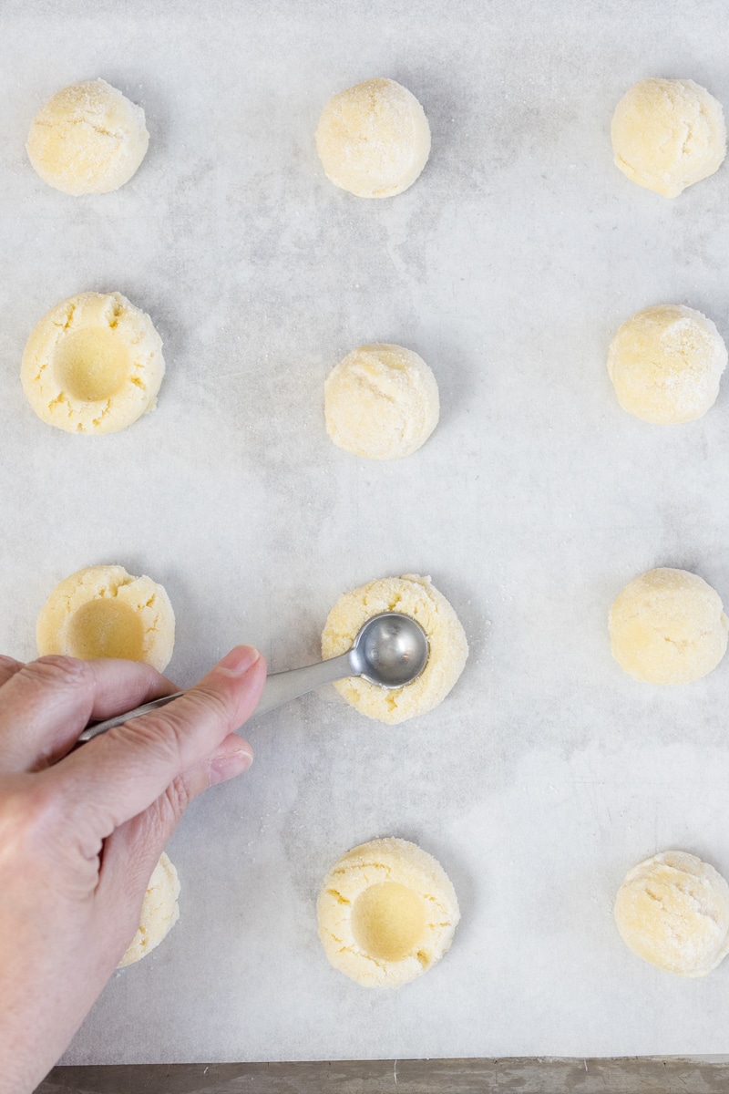 Press teaspoon into cookie dough making a well before baking