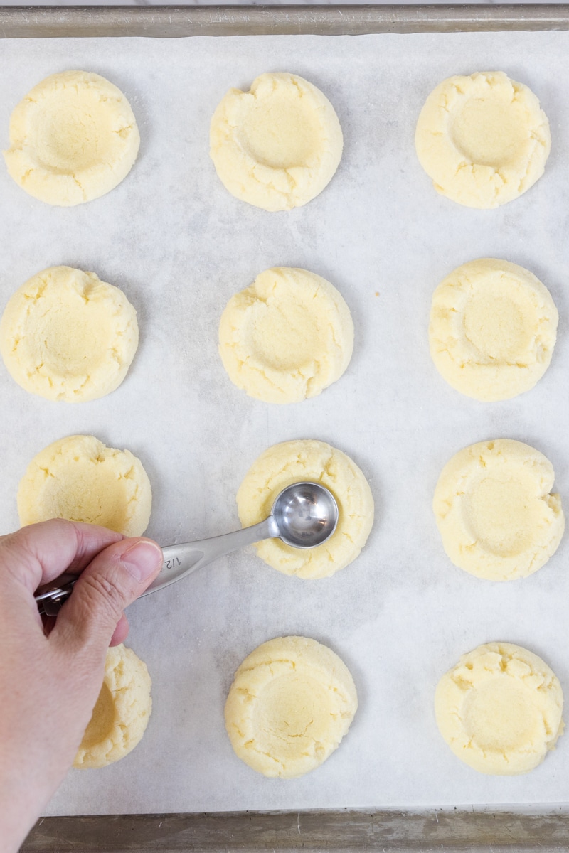 Use a teaspoon press into thumbprint cookies after baking