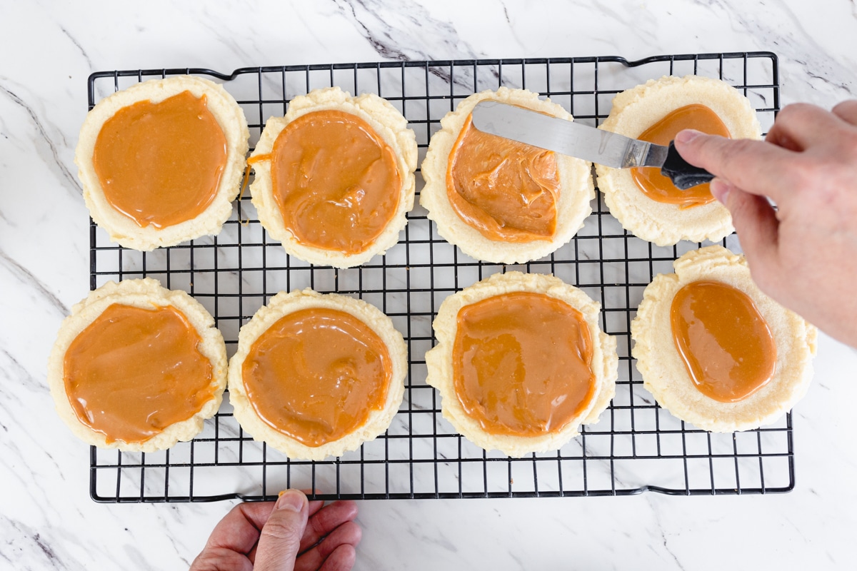 Add caramel to cooled sugar cookies