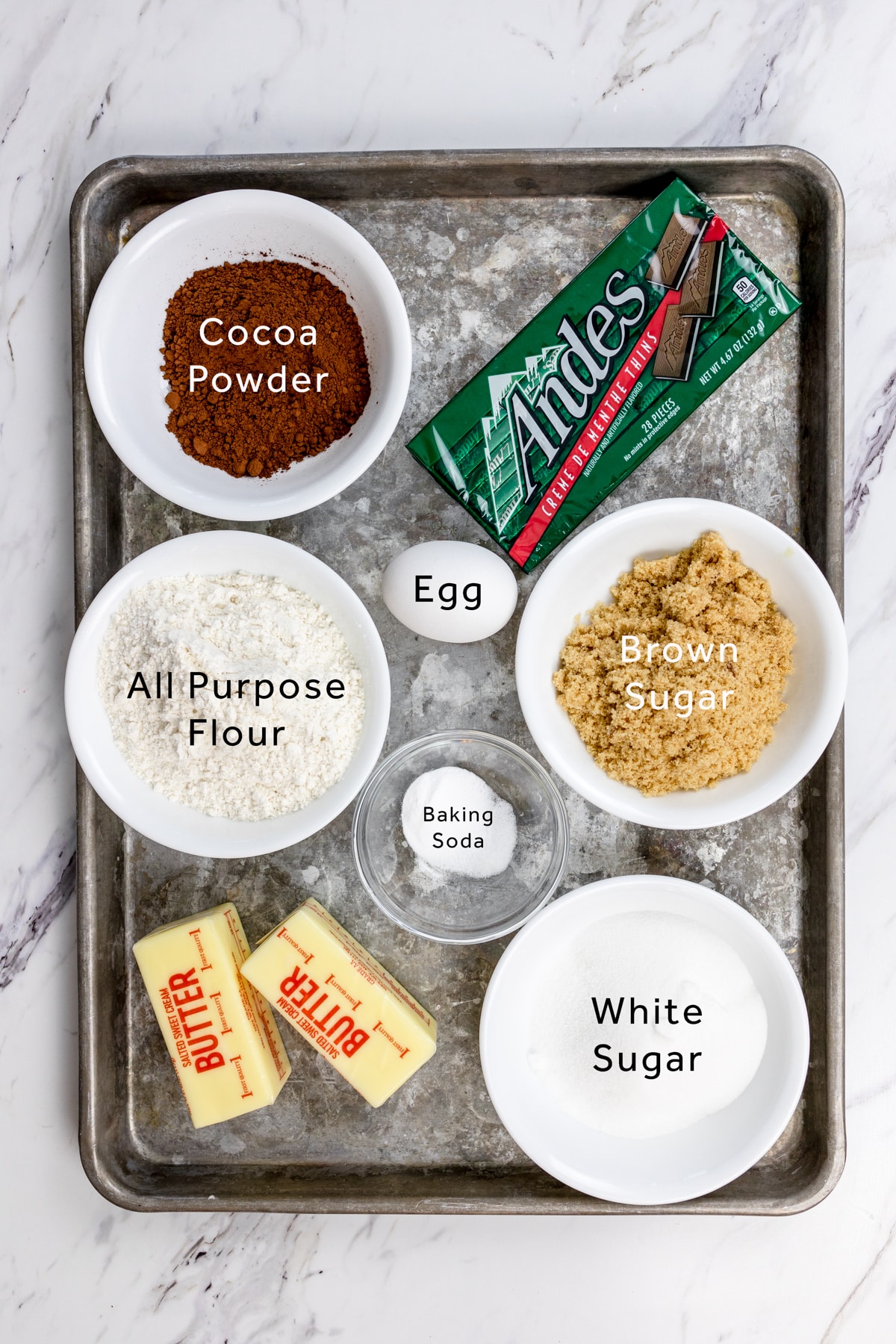 Top view of ingredients needed to make Andes Mint cookies on a baking tray. 