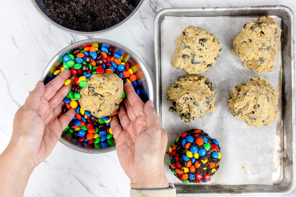 M&M candy pieces pressed into cookie dough before baking