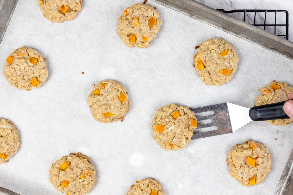 Top view of mango cookies on a baking sheet on parchment paper.