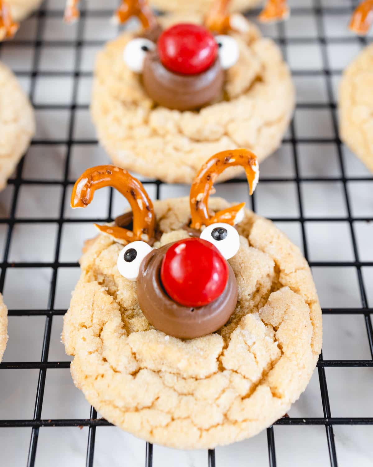 Close up of a reindeer cookie on a wire rack.