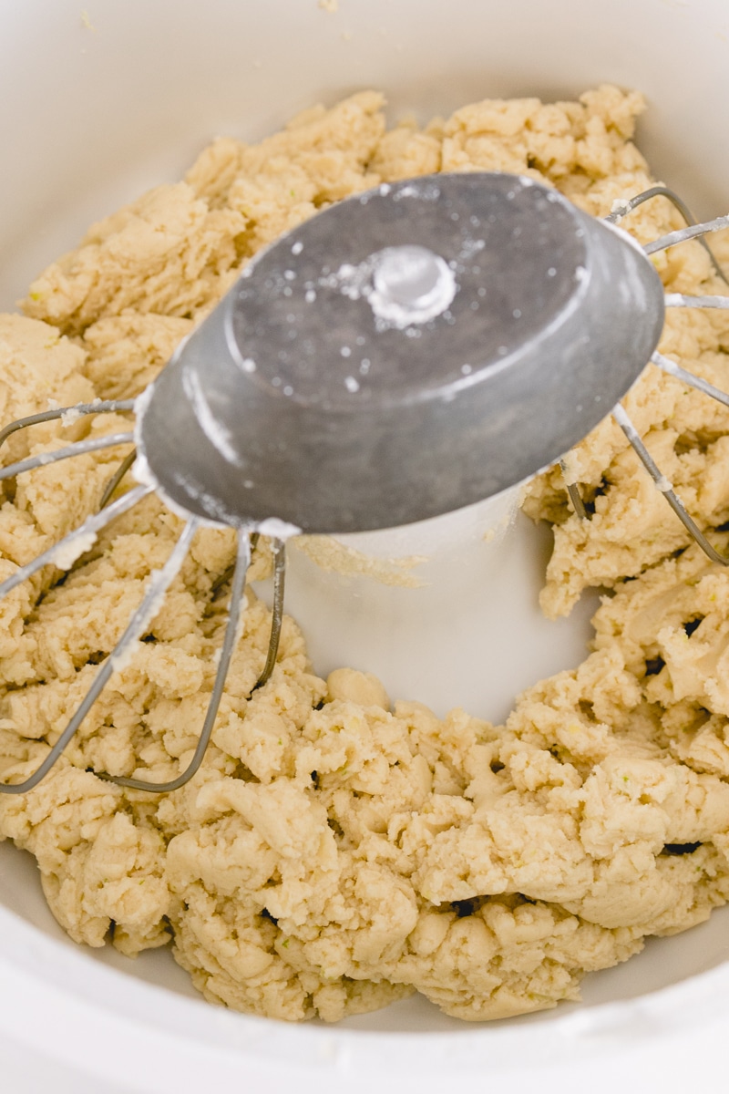 Top view of cookie dough being mixed in a stand mixer.