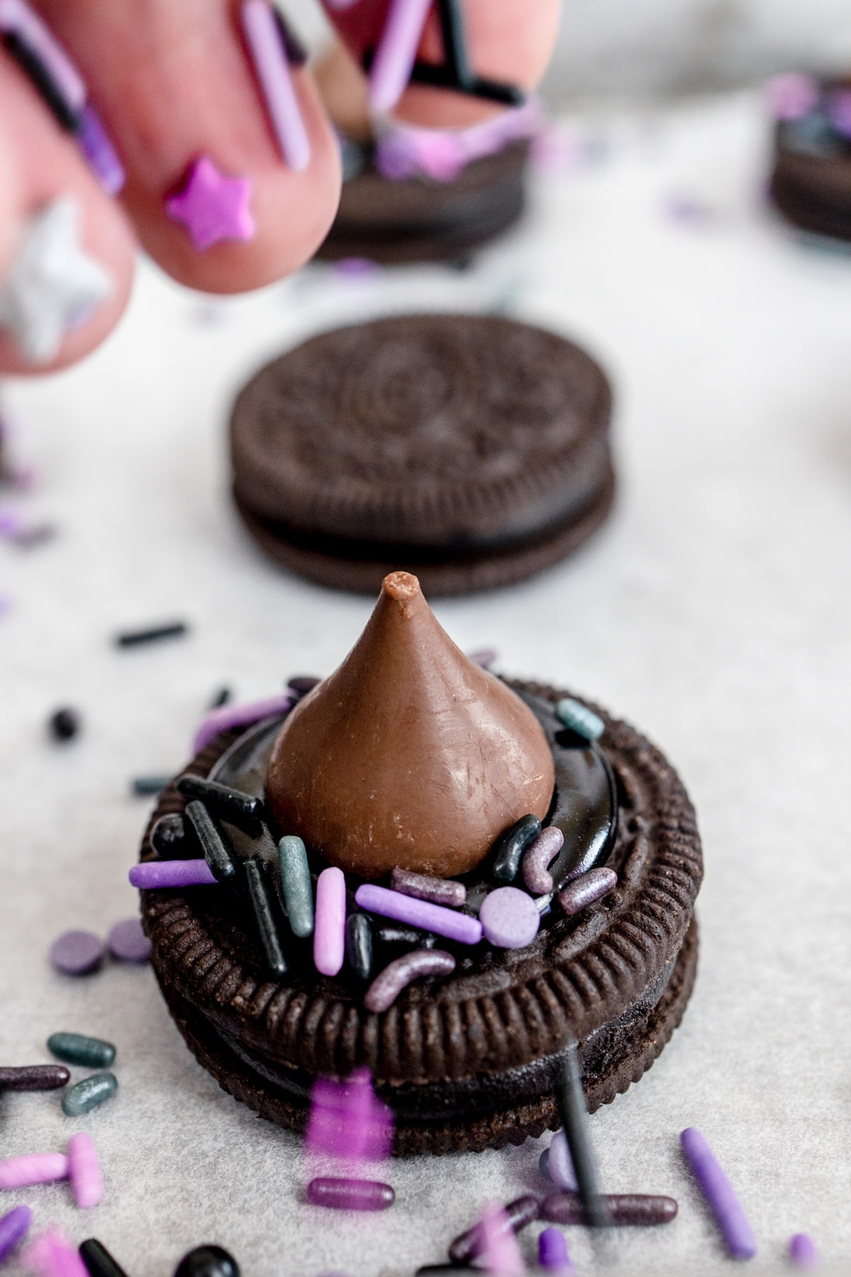 Adding Sprinkles to frosting for No Bake Witches Hat Cookies