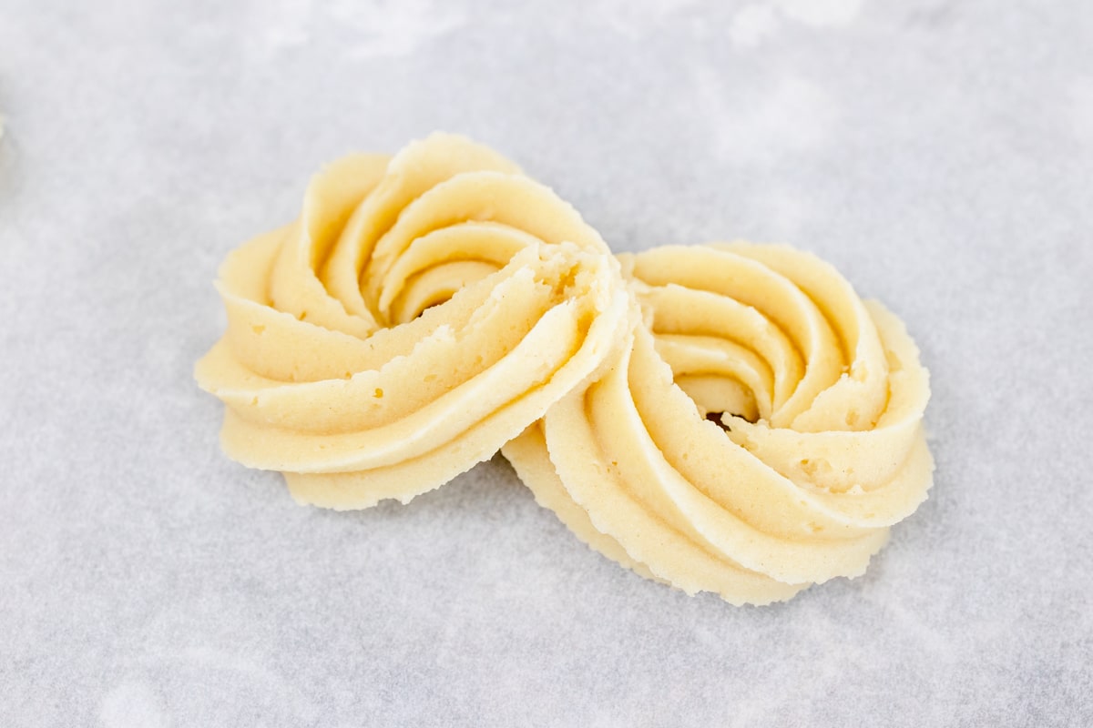 Close up of a figure of 8 butter cookie dough shape. 