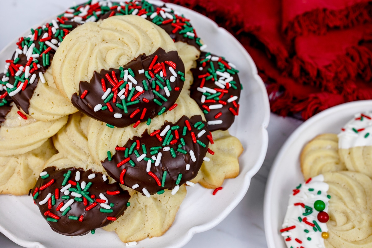 Close up of a plate filled with decorated Christmas butter cookies.