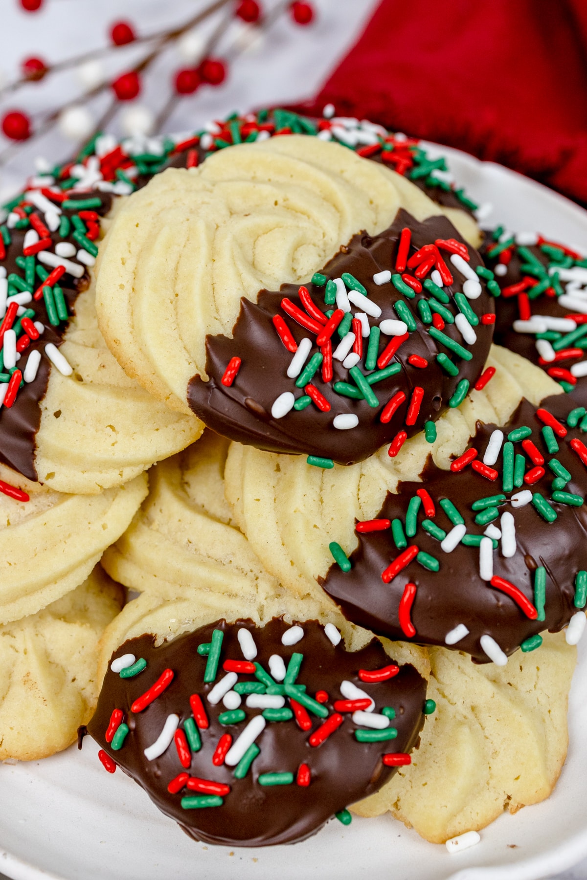 Swirl butter cookies with chocolate and festive sprinkles on them.