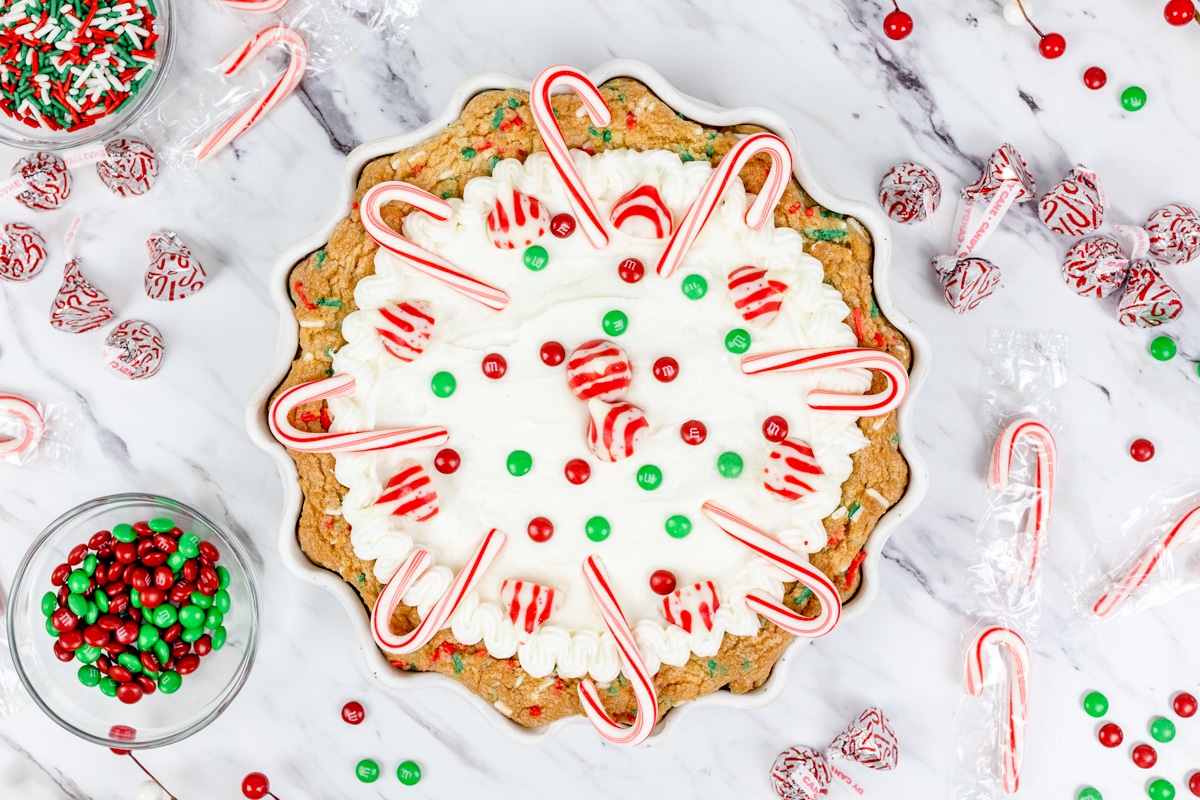 Top view of Christmas cookie pie decorated with festive candy.