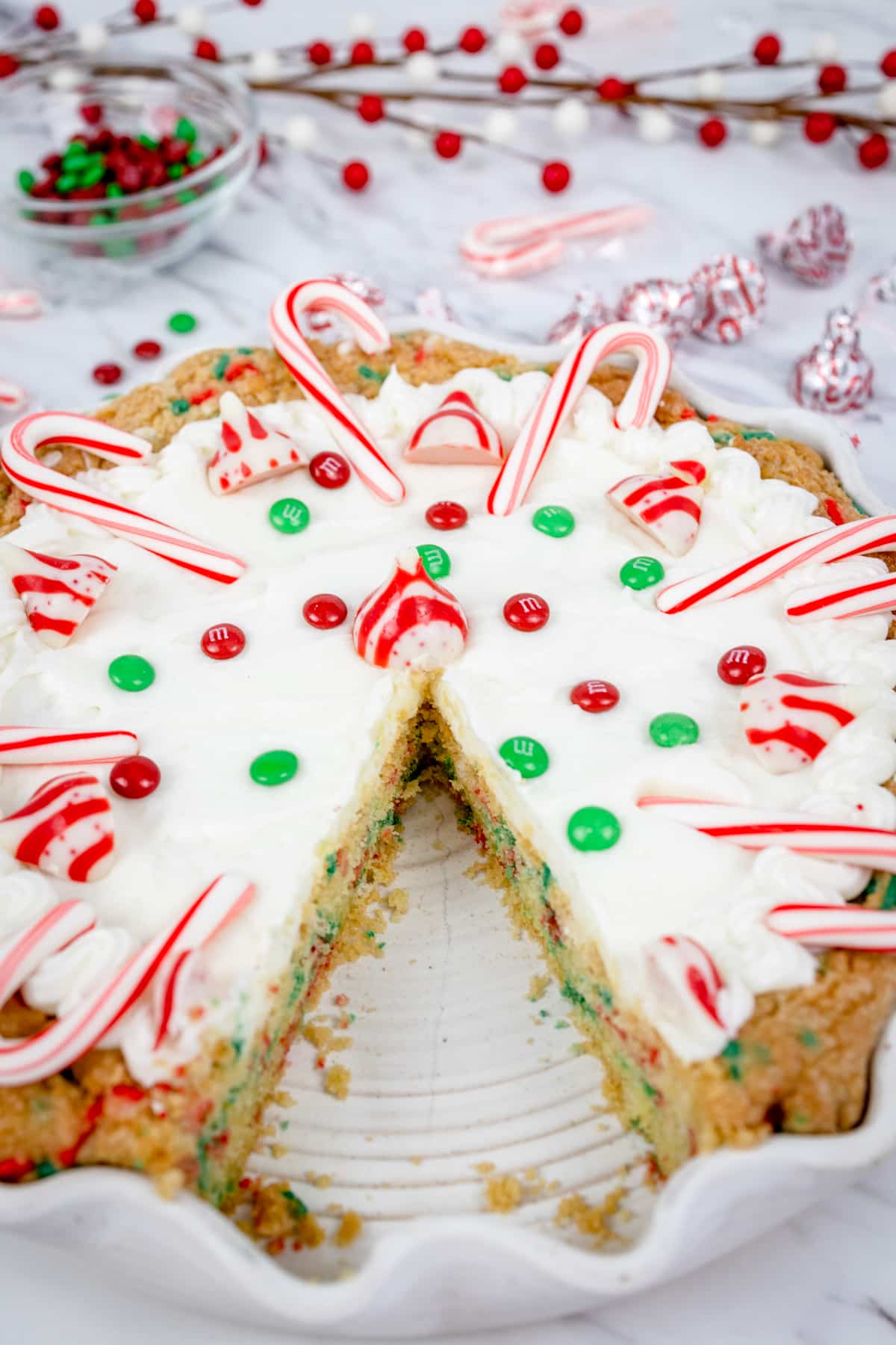 Close up of Christmas cookie pie with a slice cut out of it.