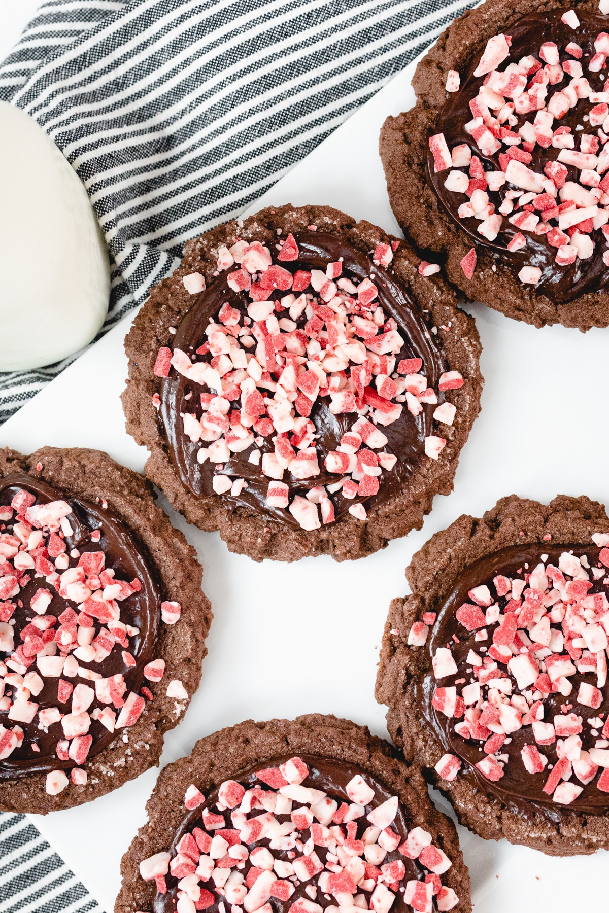 Top view of giant chocolate peppermint cookies on a white tray. 