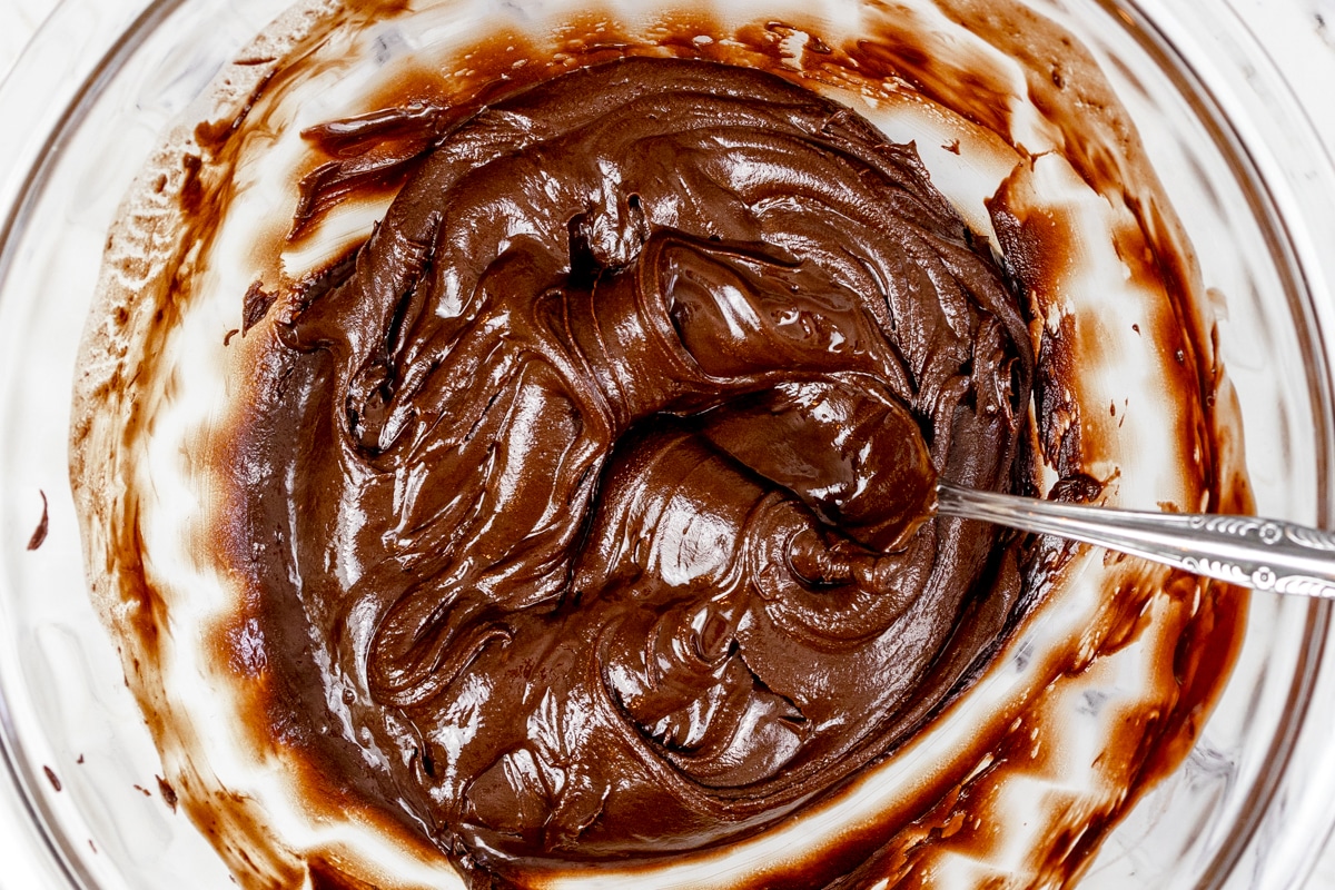 Top view of a glass mixing bowl with  melted chocolate in it 