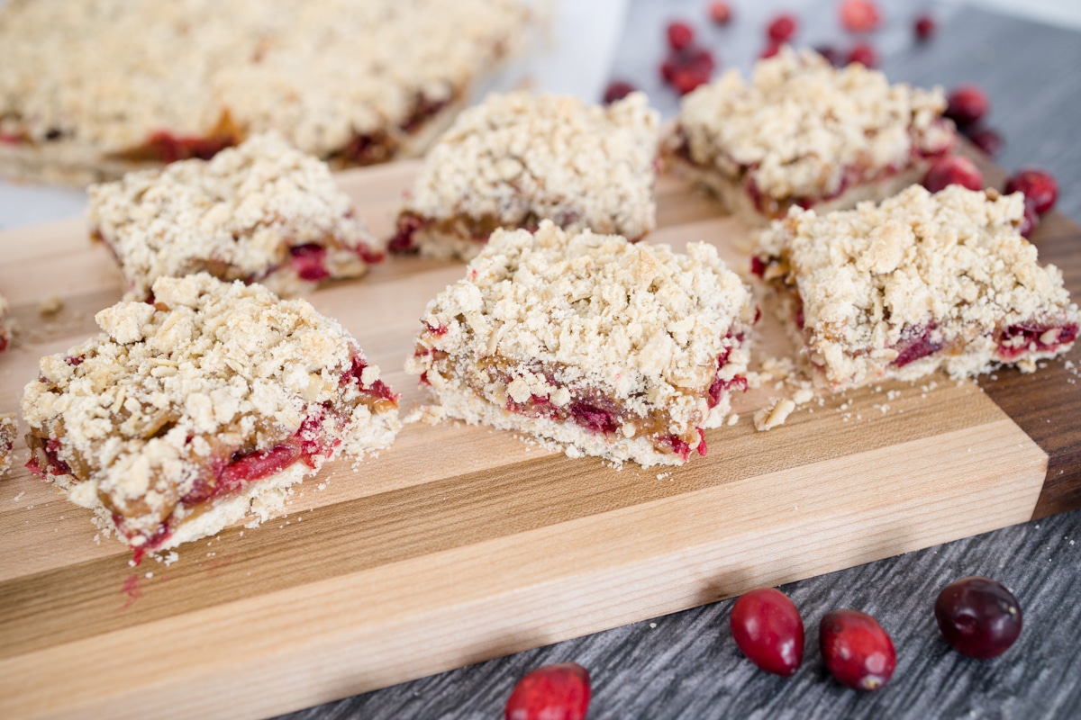 Close up of cranberry bar squares on a chopping board. 