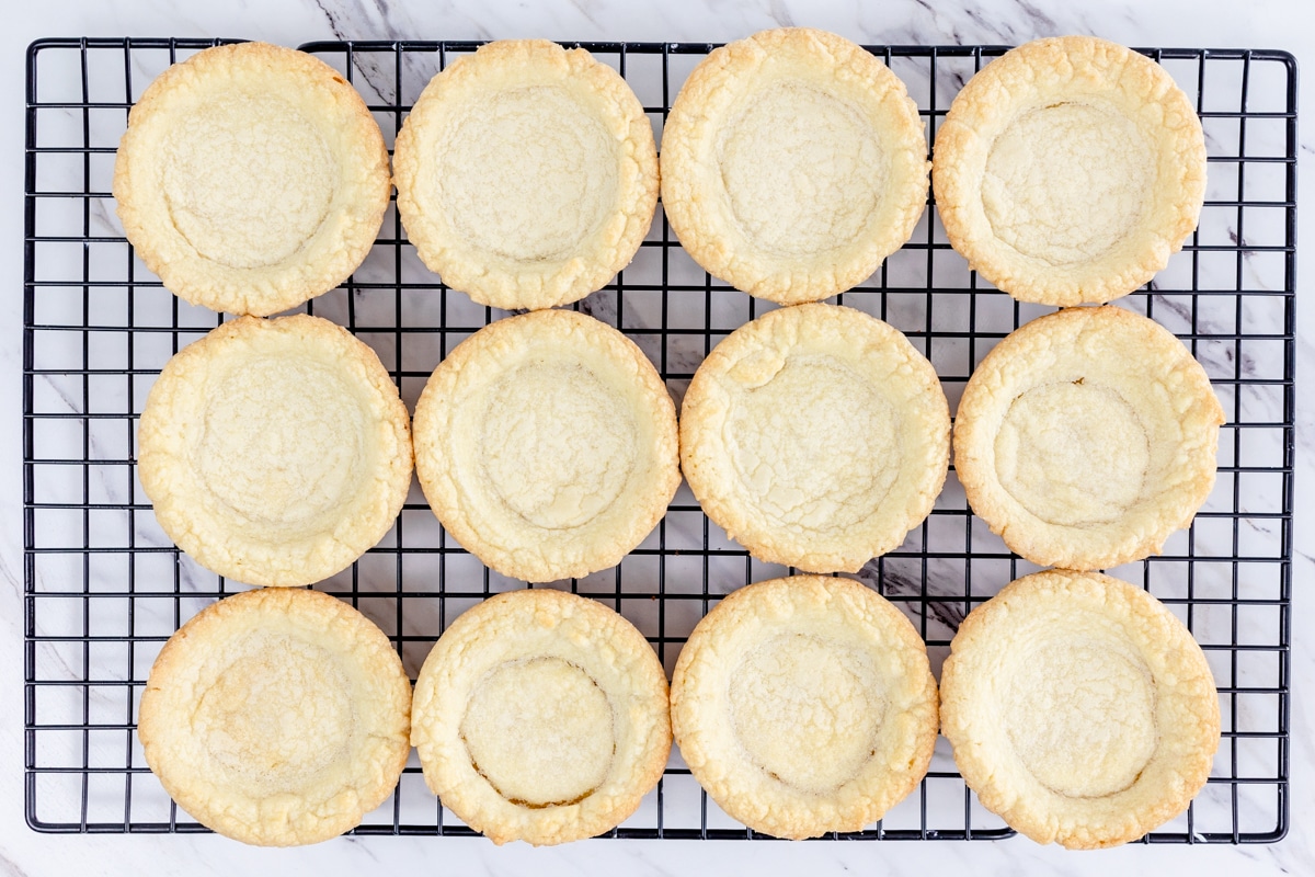 Top view of sugar cookies in a pie shape on a grid on a wire rack.