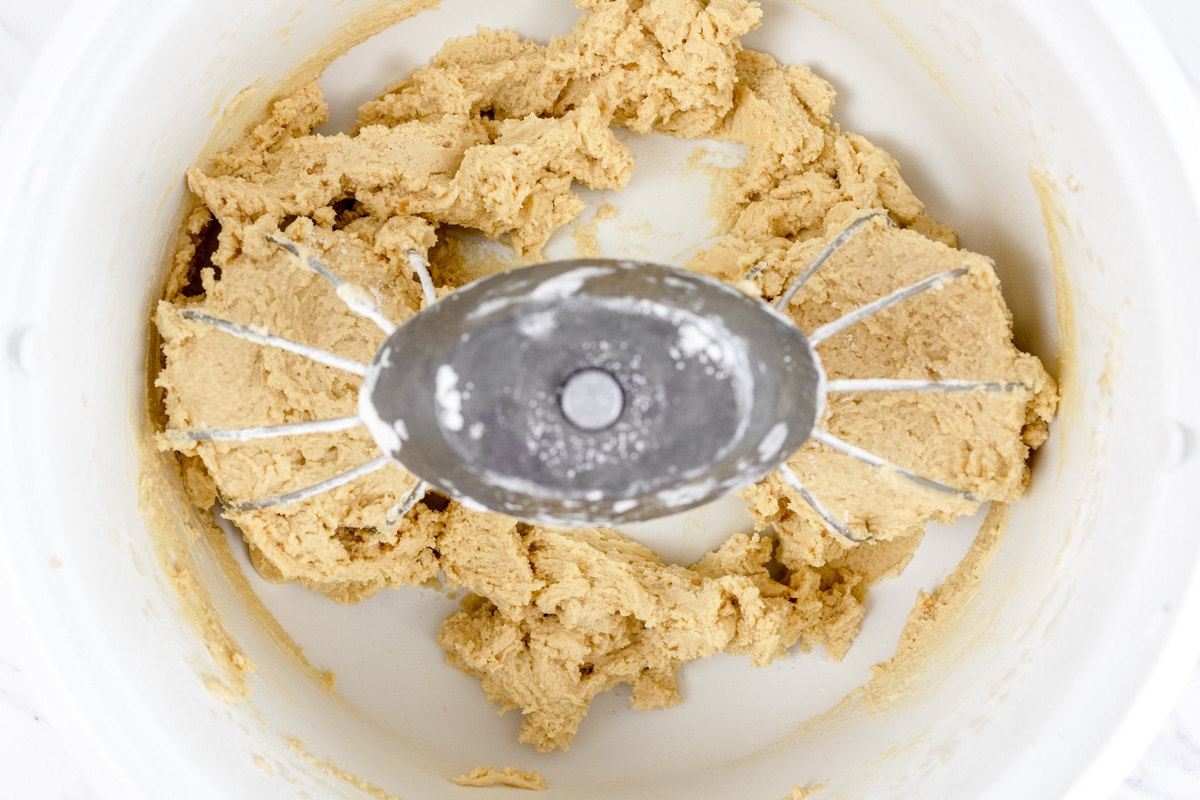Top view of cookie dough being made in a stand mixer with a paddle attachment. 
