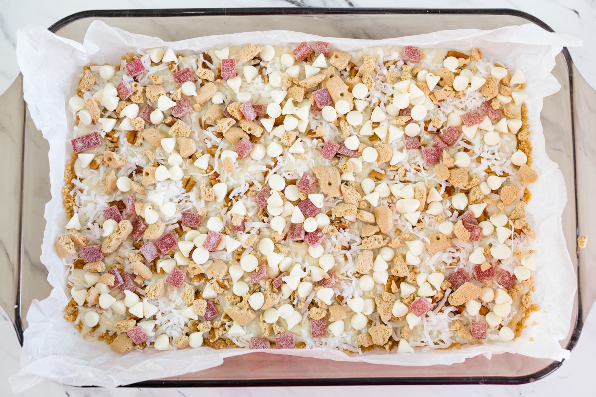 Top view of a baking dish with a traybake in it, topped with a later of Nestle Strawberry and Cream Morsels & More. 
