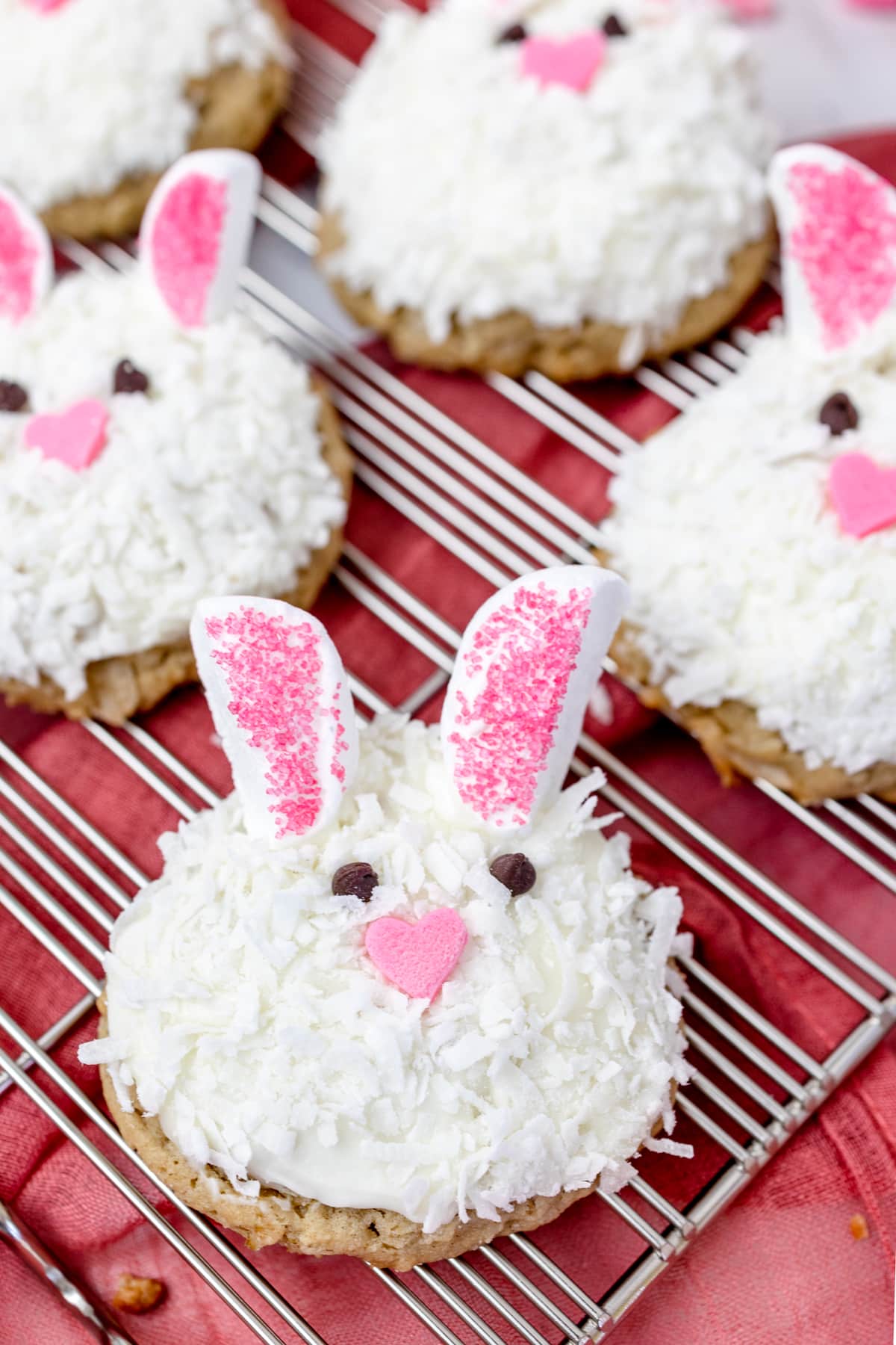 Close up of Easter bunny cookie faces on a wire rack. 