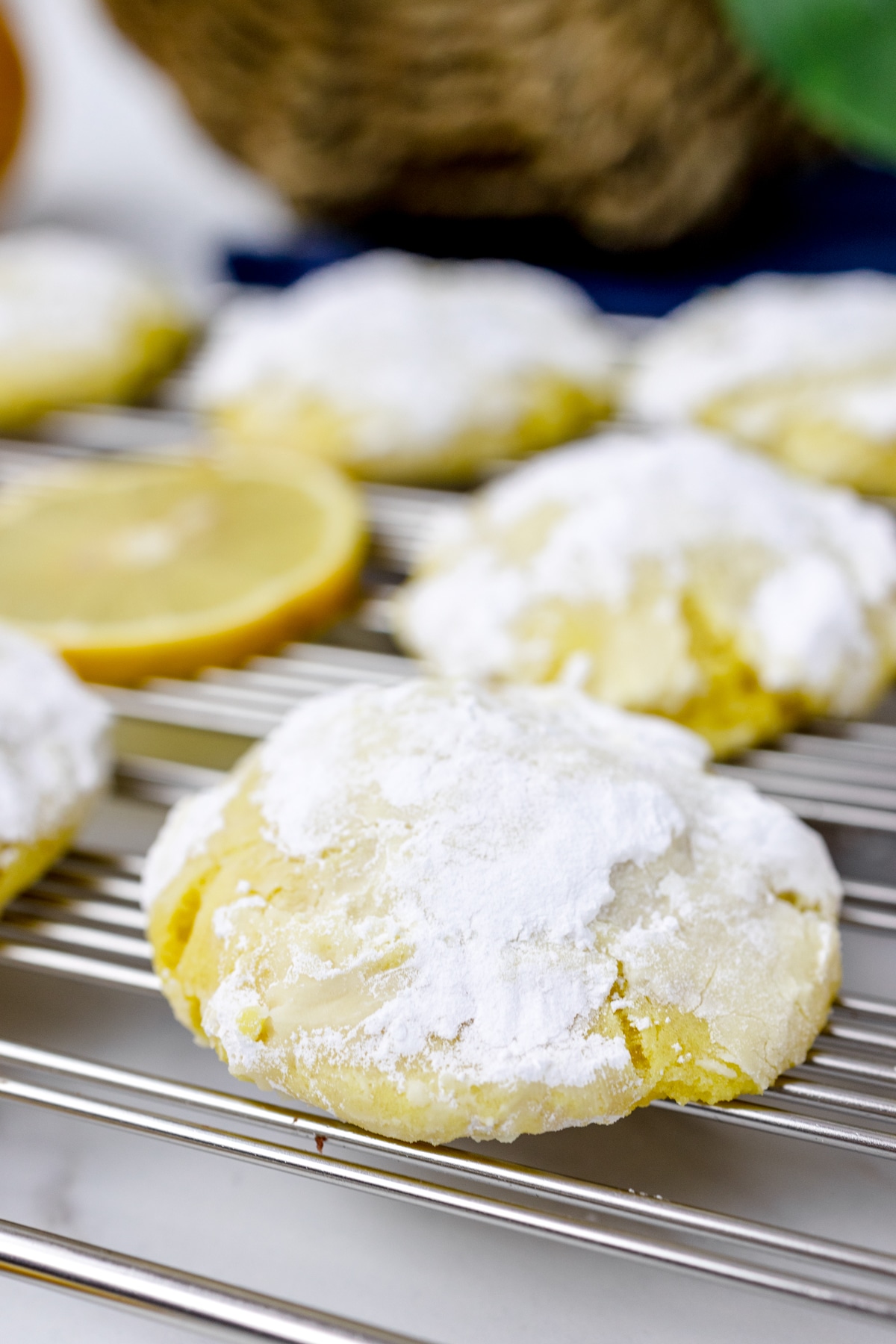 Close up of Lemon Crinkle Cookies on a wire rack. 