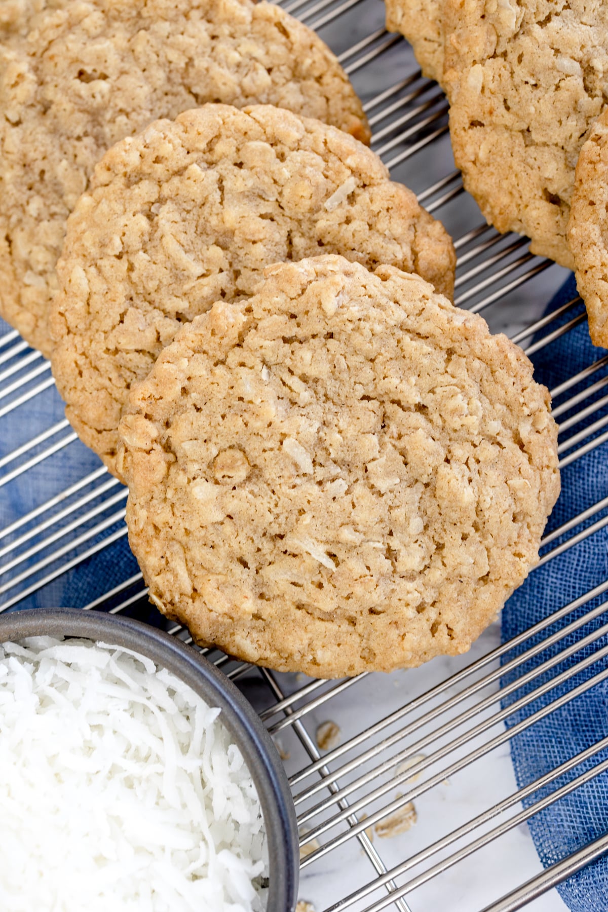 Top view of oatmeal coconut cookies on a wire rack. 