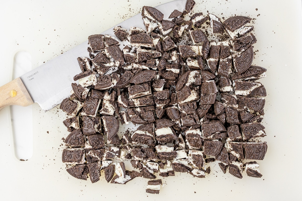 Top view of crushed Oreo chunks on a white surface.