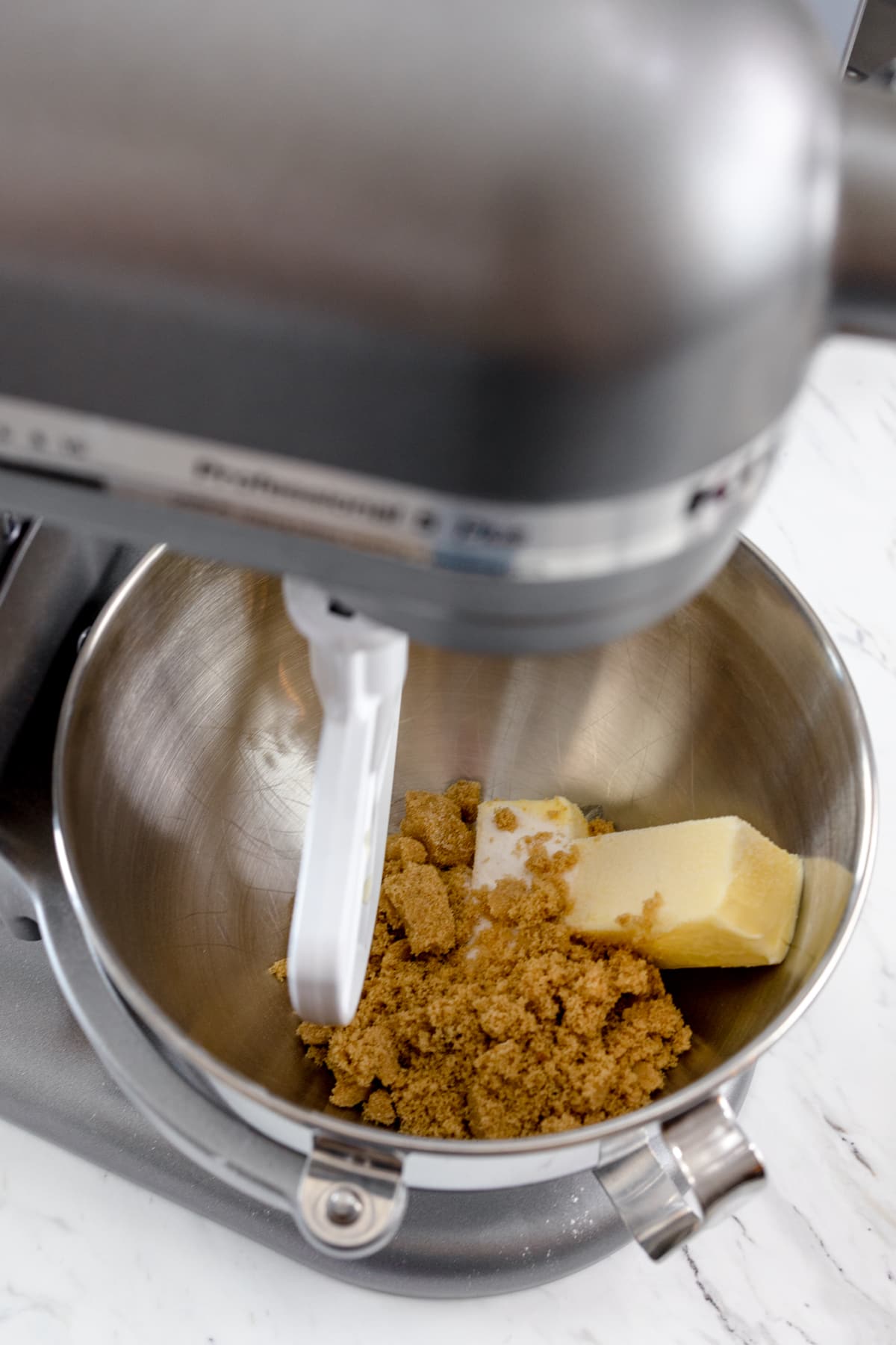 close up of butter and sugar being creamed together in a stand mixer. 