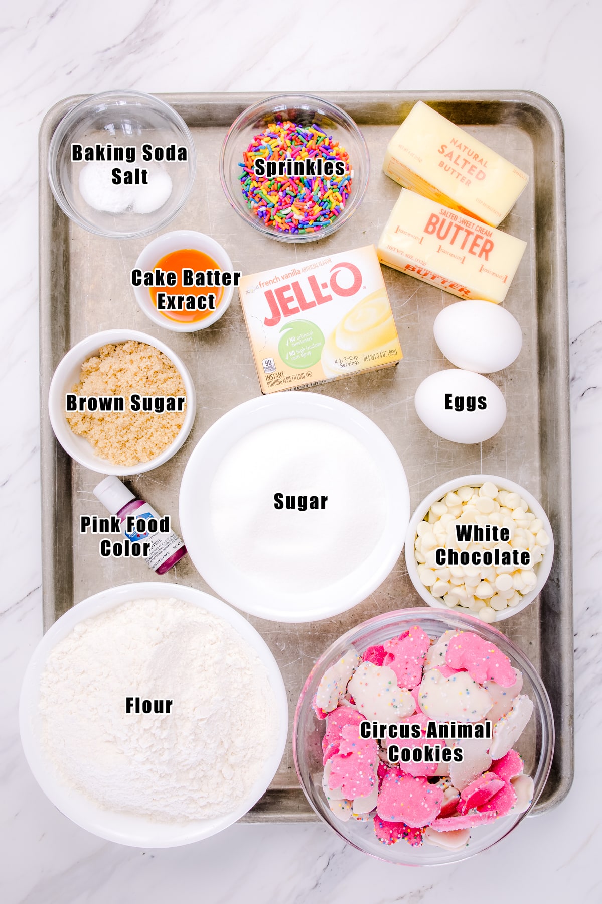 Top view of ingredients needed to make circus animal cookies in a small bowl on a baking tray. 
