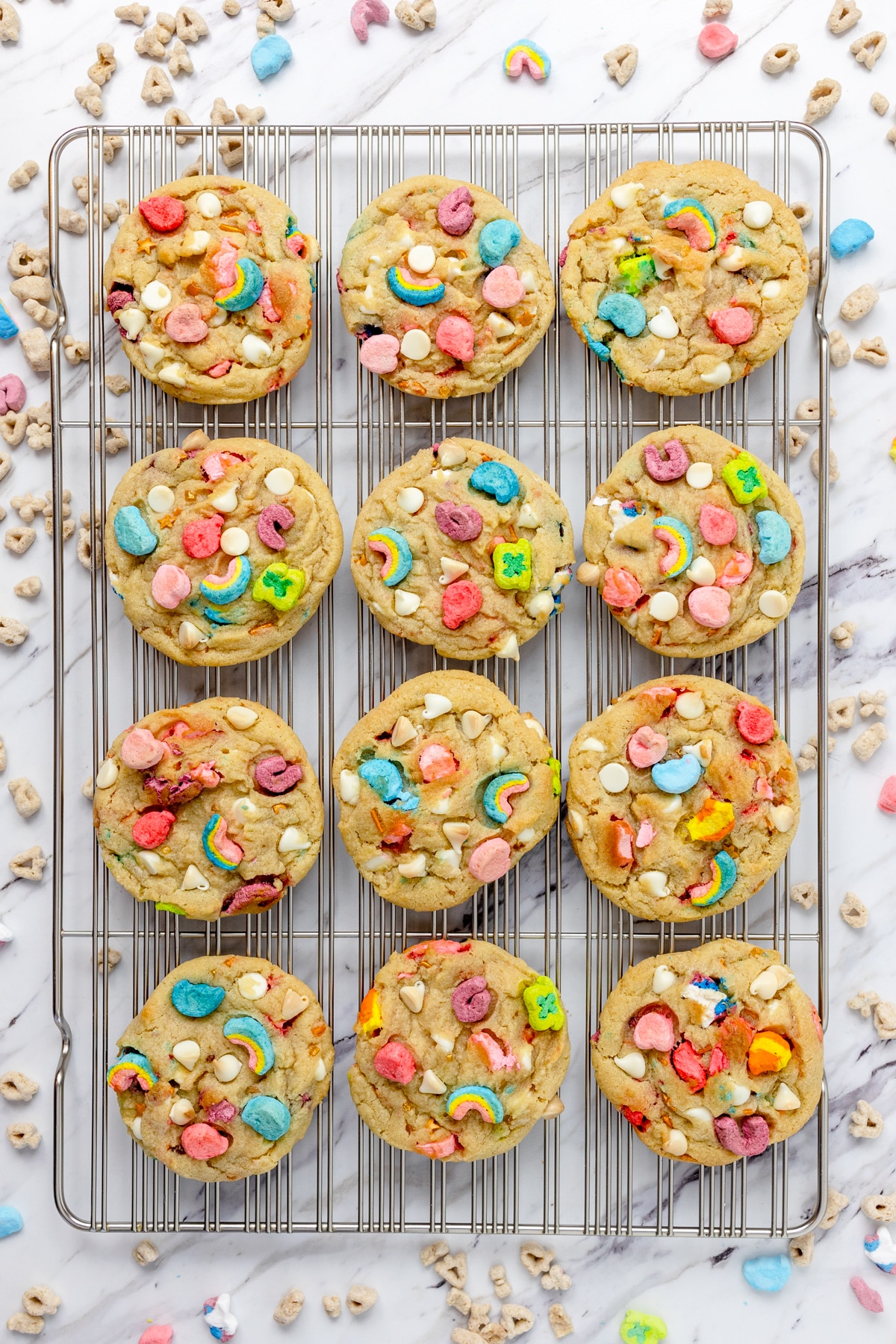 Top view of freshly baked Lucky Charms Cookies on a wire rack.