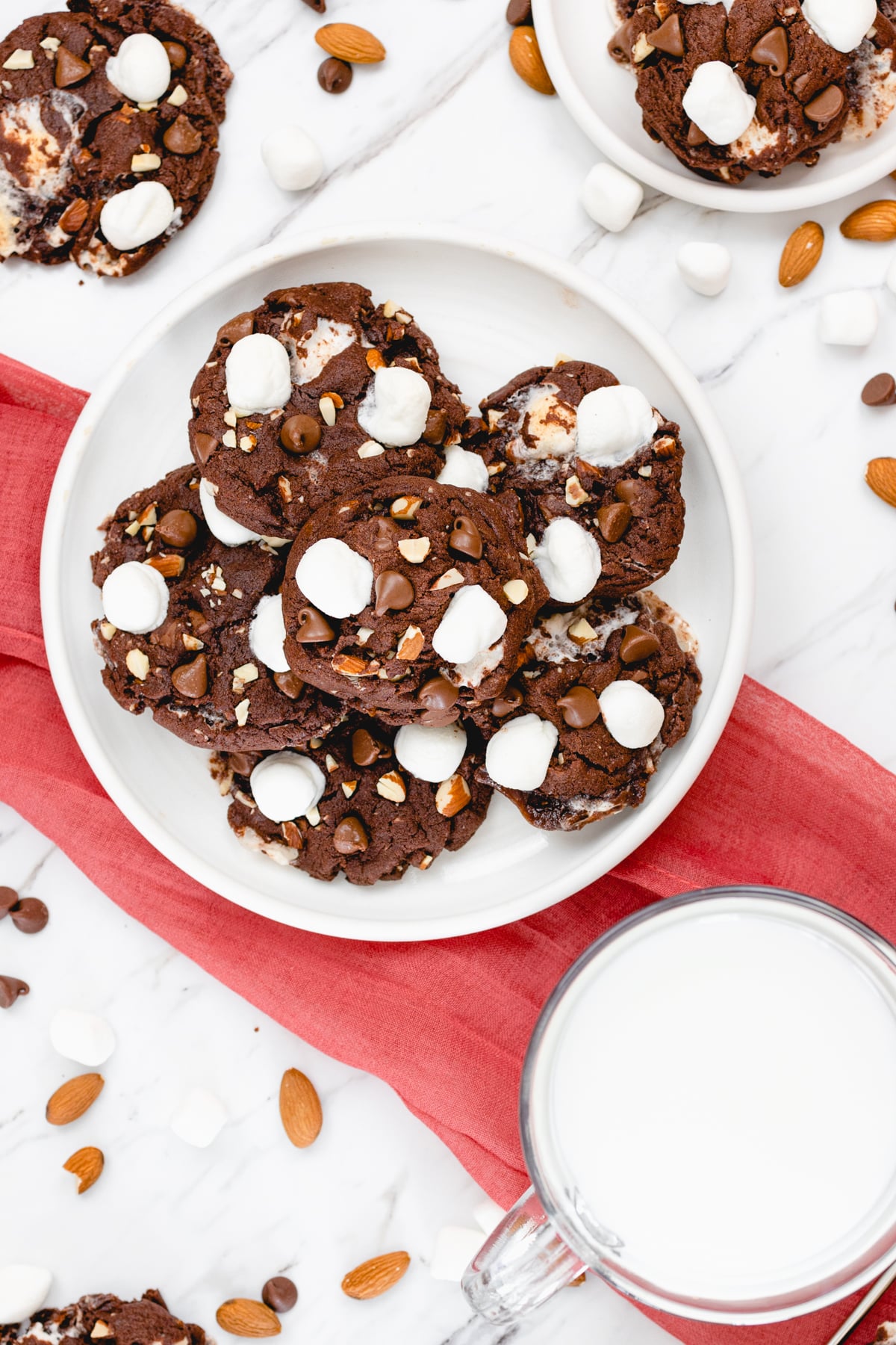 Top view of rocky road cookies on a white plate. 