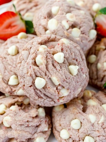 Close-up of Strawberry White Chocolate Chip Cookies in a pile.