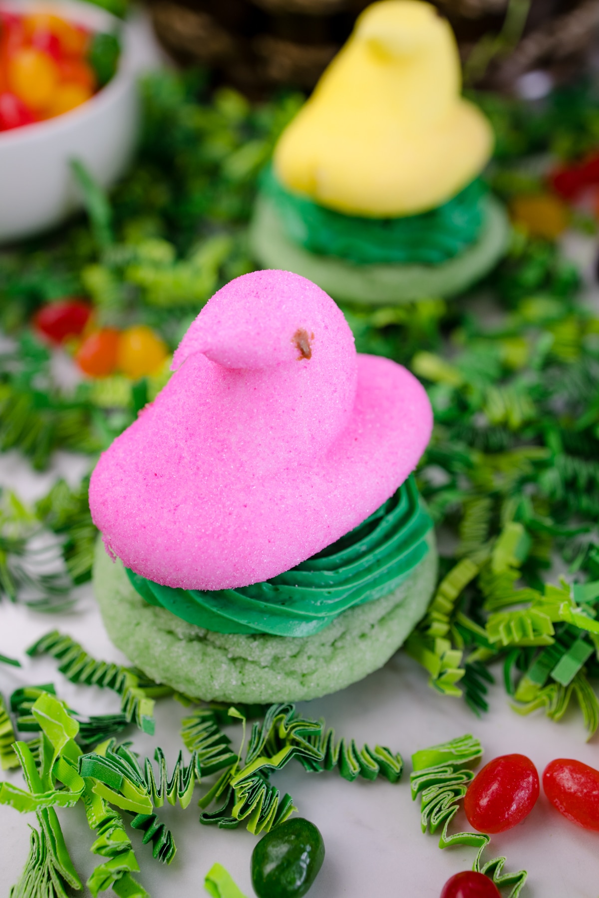 Hero image of Peeps Cookie Nest Cookie, wiht a green base and a pink candy bird sitting on top of it. 