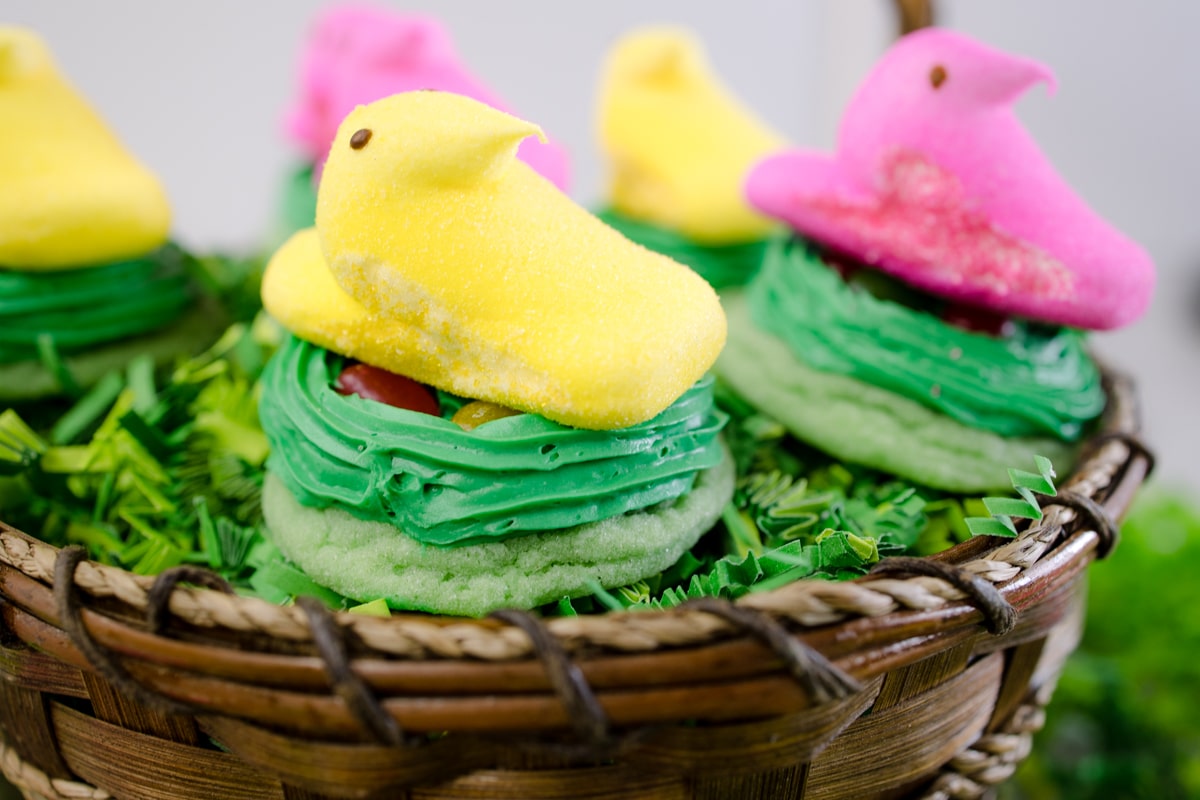 Close up of two Peep Nest Cookies sitting in an Easter Basket. 