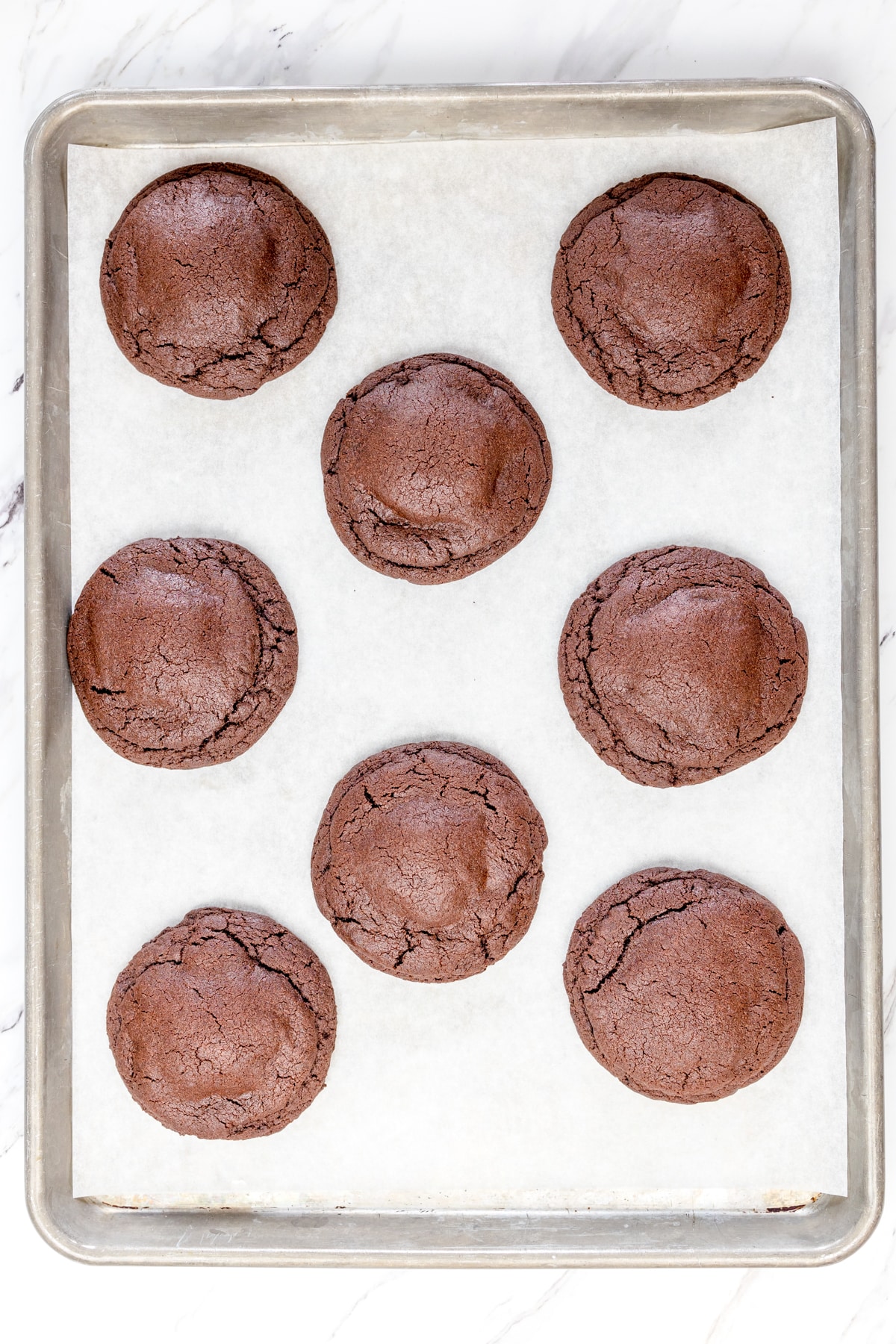 Top view of peppermint patty stuffed cookies on a baking tray. 