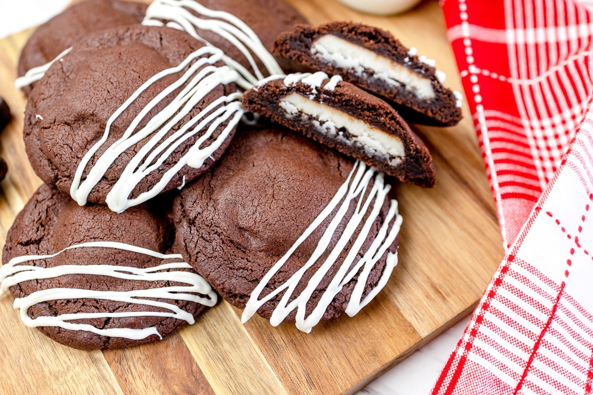 Close up of a pile of chocolate peppermint patty cookies on a chopping board. 