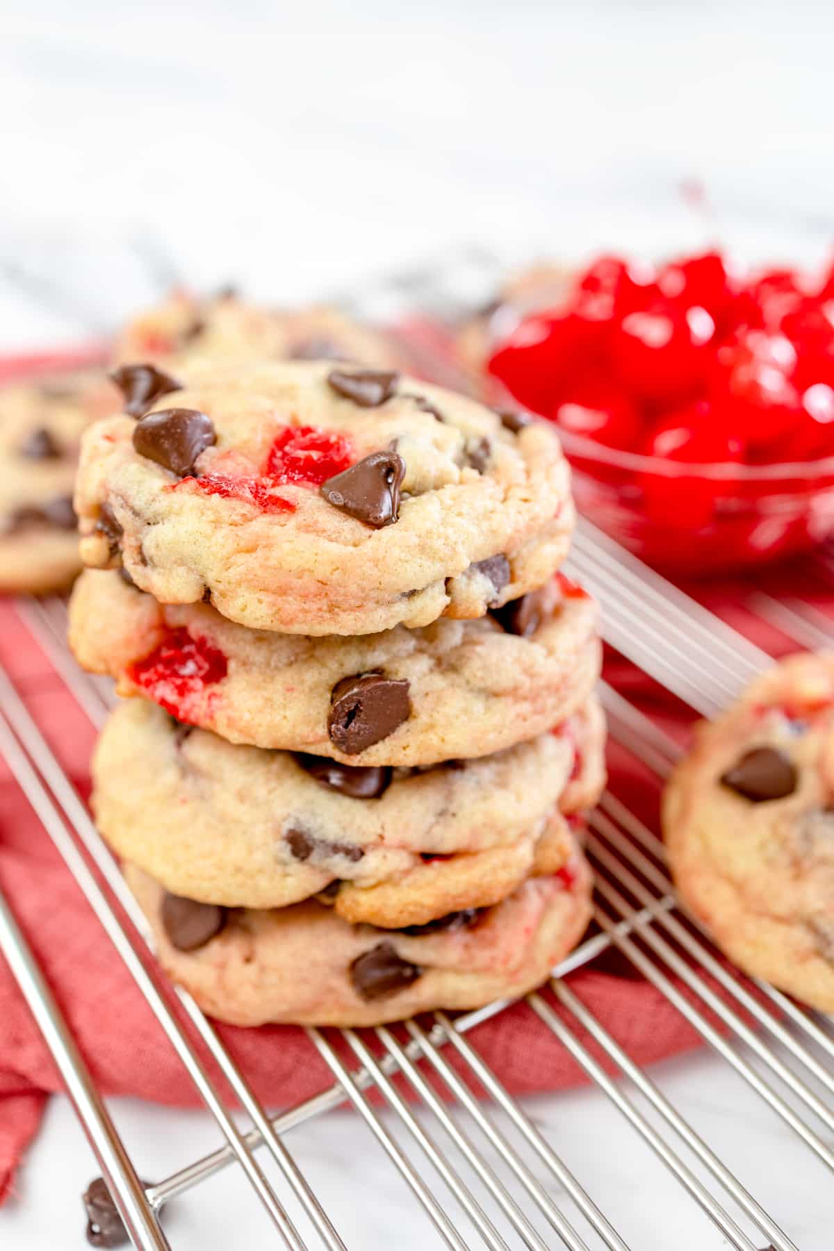A stack of Cherry Chocolate Chip Cookie on a wire rack.
