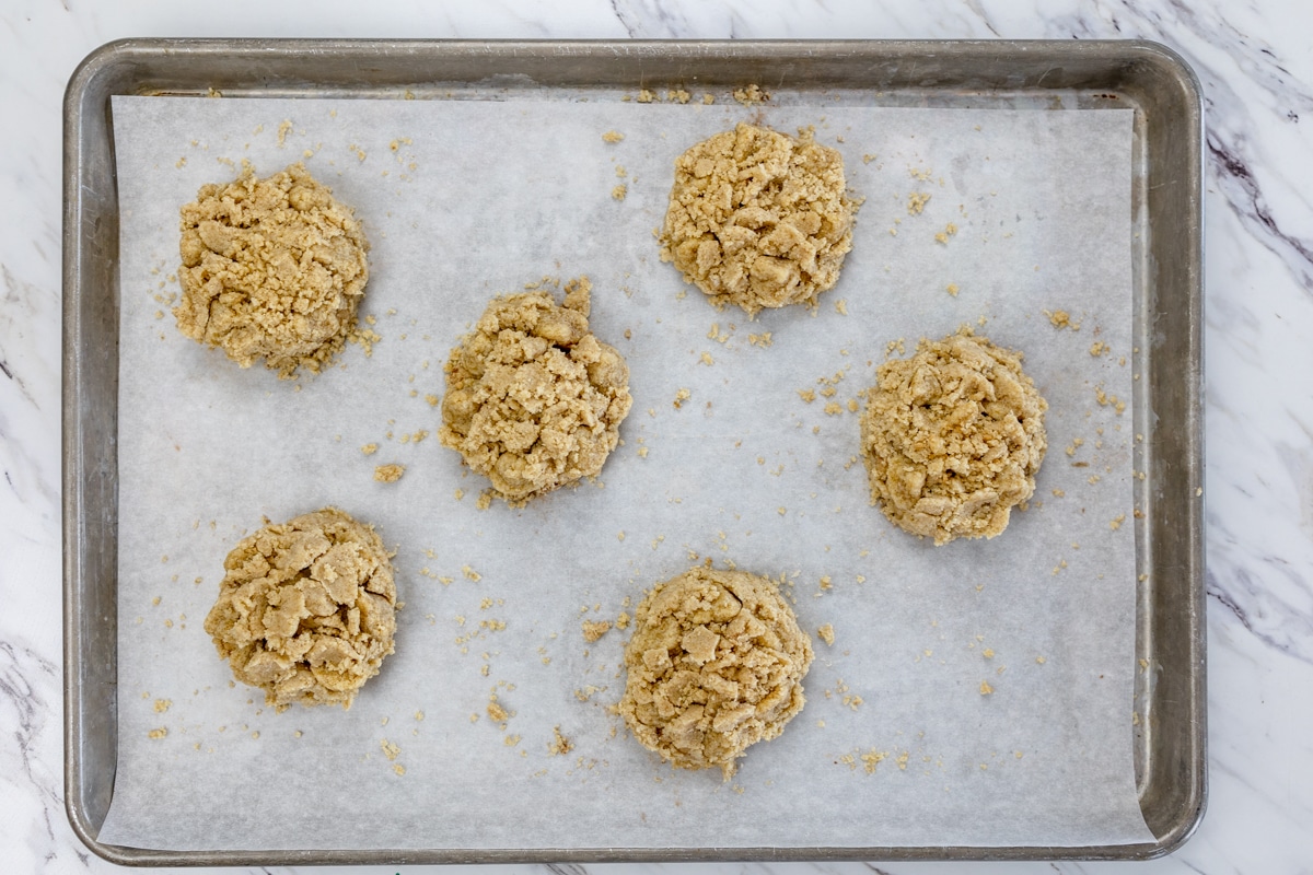 Top view of coffee cake cookie dough balls on a baking tray lined with parchment paper.