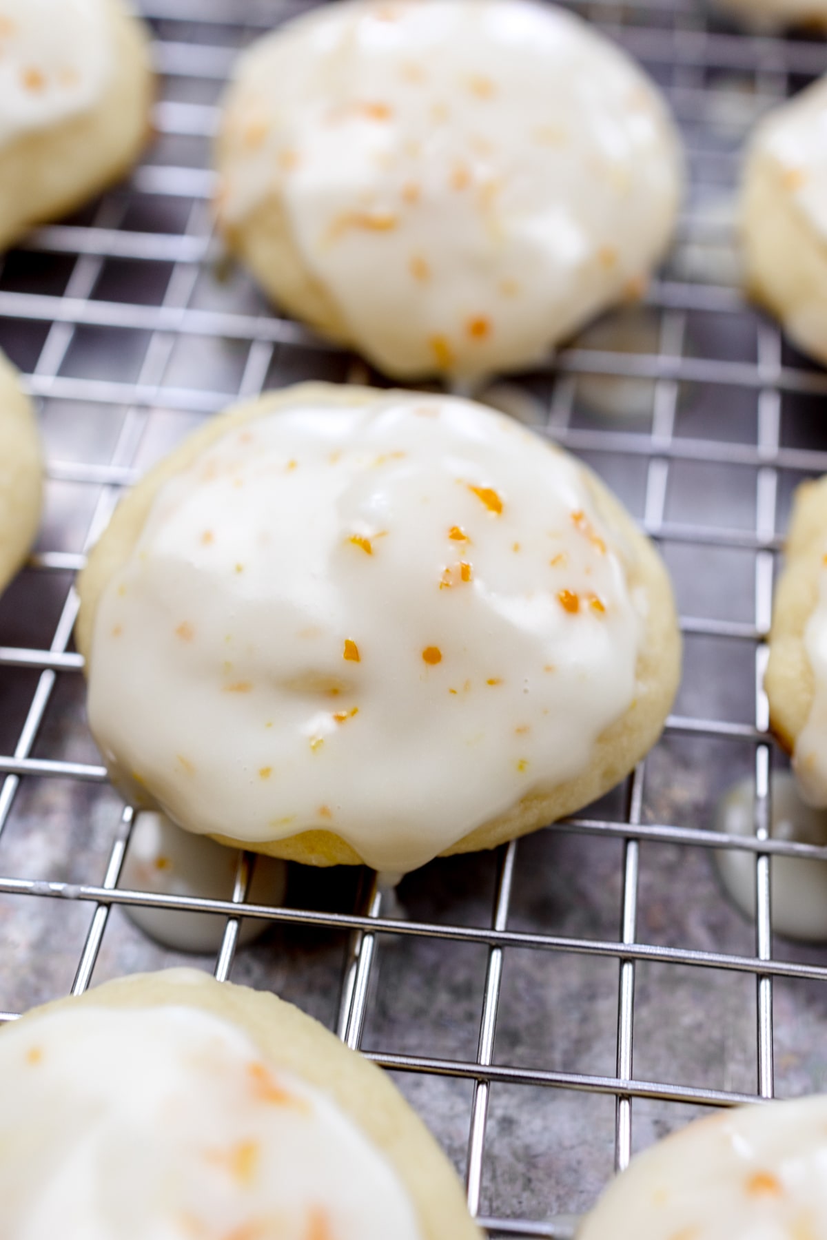 Close up of lemon ricotta cookies on a wire rack.