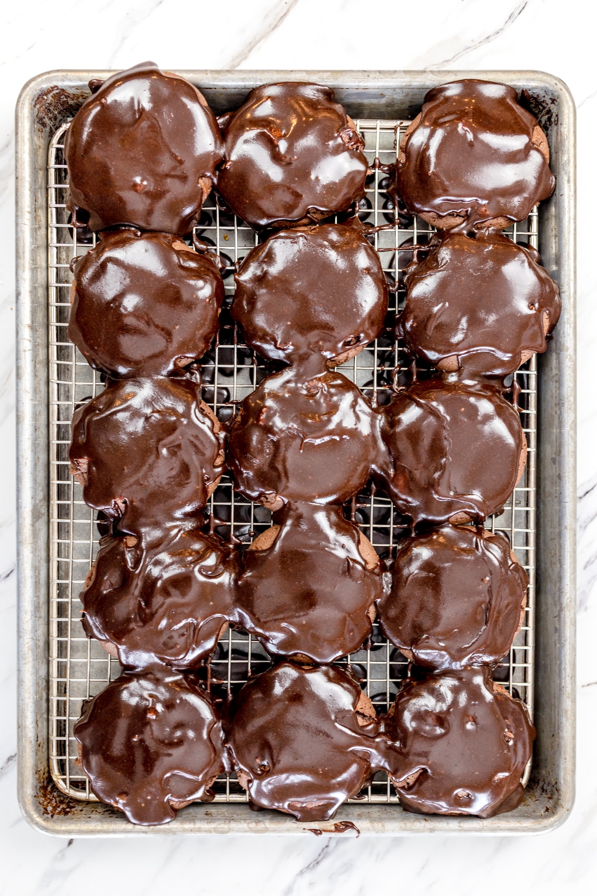 Top view of chocolate Texas Sheet Cookies covered in frosting on a wire rack. 