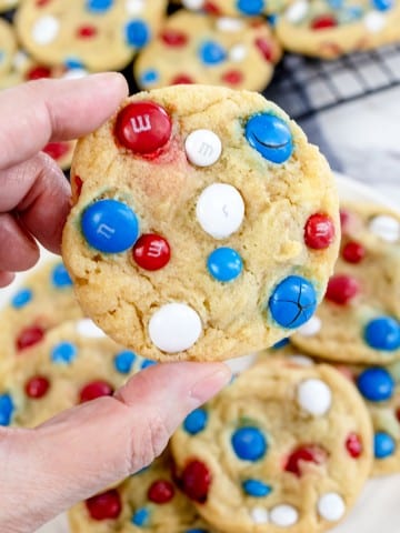 Close up of a 4th of July Cookie with M&M's being lifted in mid-air.
