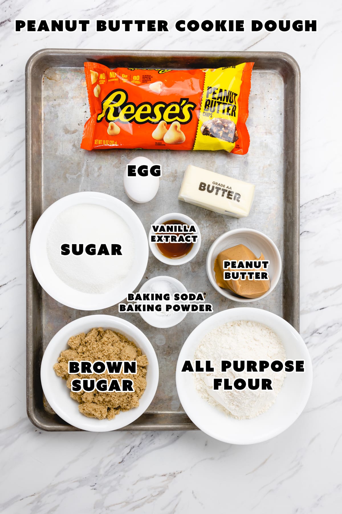 Top view of ingredients needed to make Peanut Butter Cookie dough on a baking tray.
