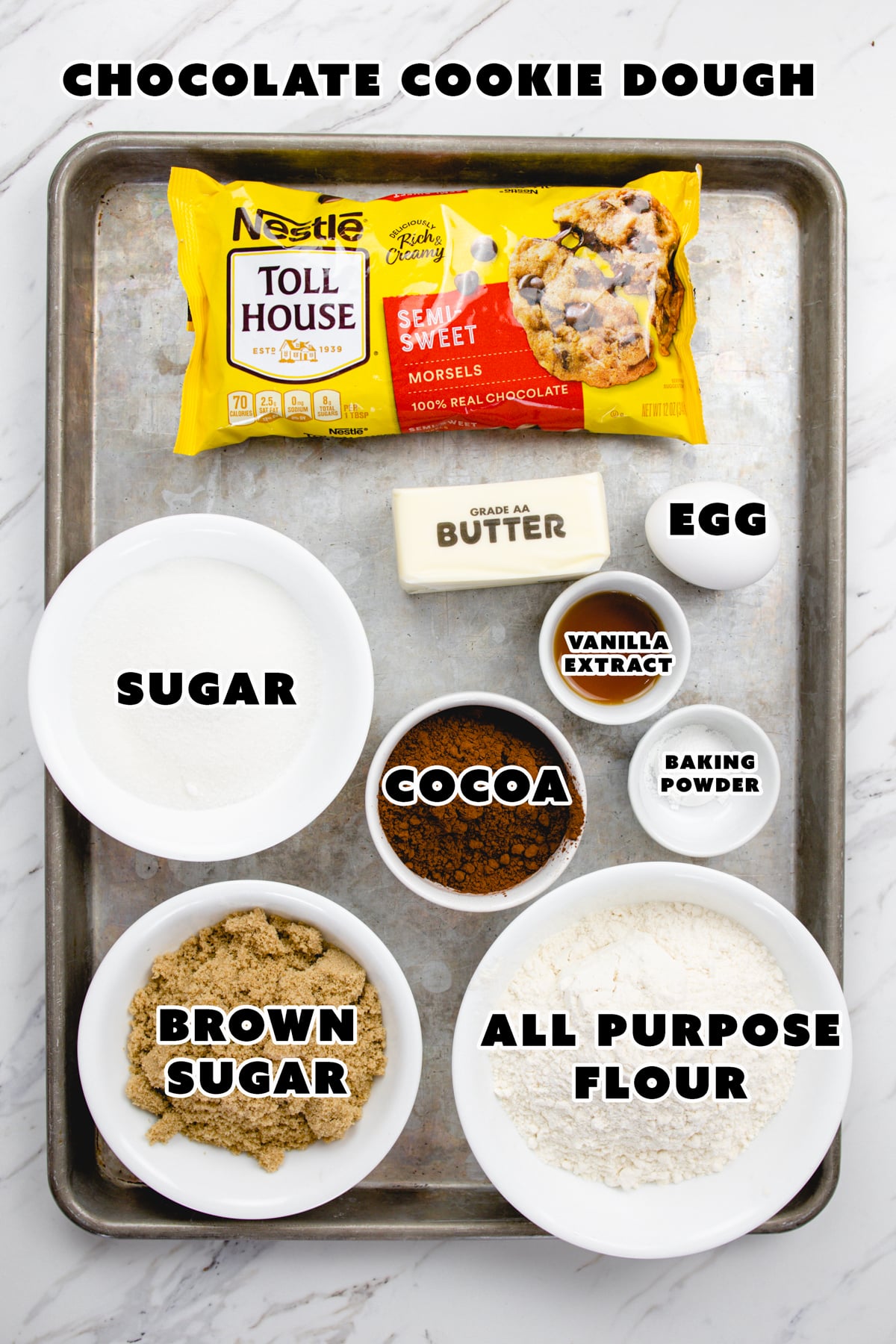 Top view of ingredients needed to make Chocolate Peanut Butter Cookie dough on a baking tray.