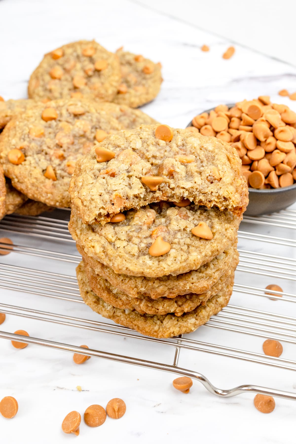 A stack of Oatmeal Butterscotch Cookies, the top one has a bite taken out of it.