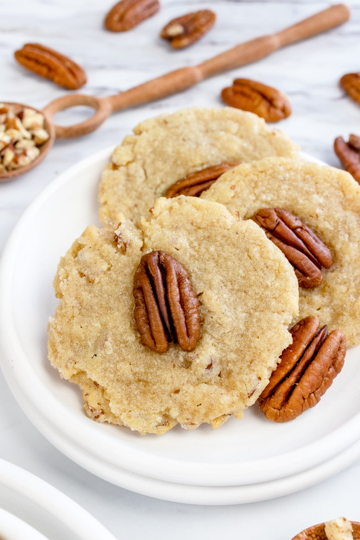 Top view close up of Pecan Sandies Cookies on a white plate.
