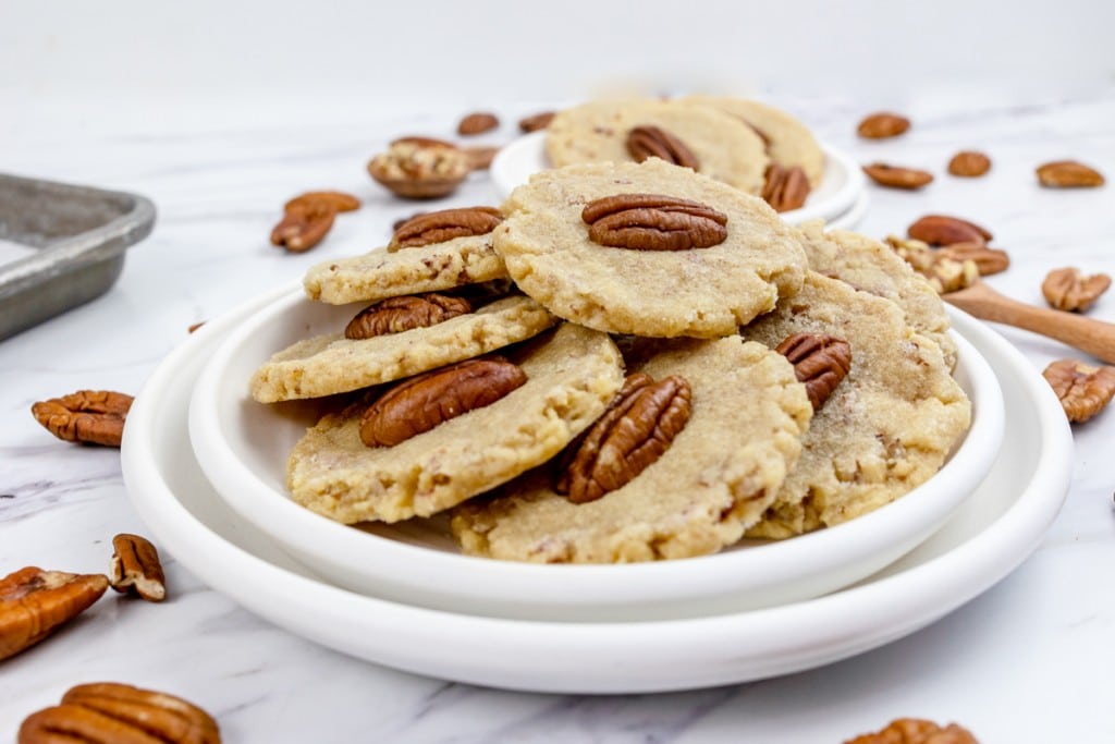 Close up of Pecan Sandies Cookies on a white plate.