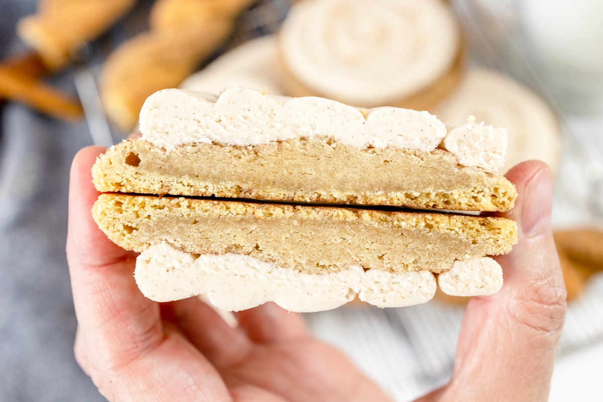 Close up of a Churro Cookie cut in half being held in mid-air so you can see the inside.