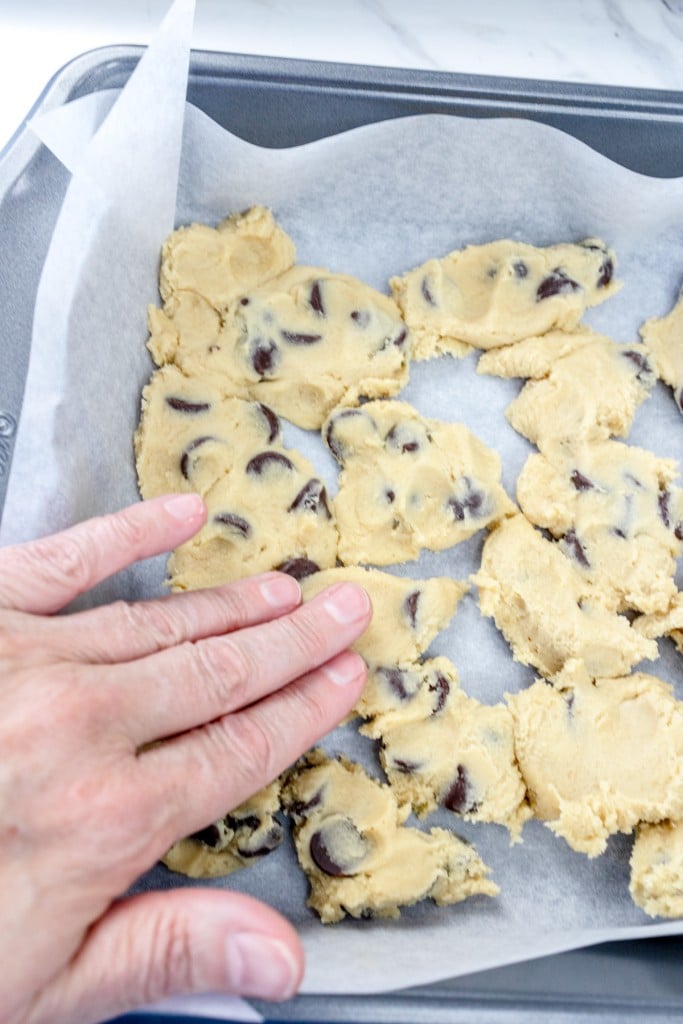Bottom layer of chocolate chip cookie dough pressed in pan