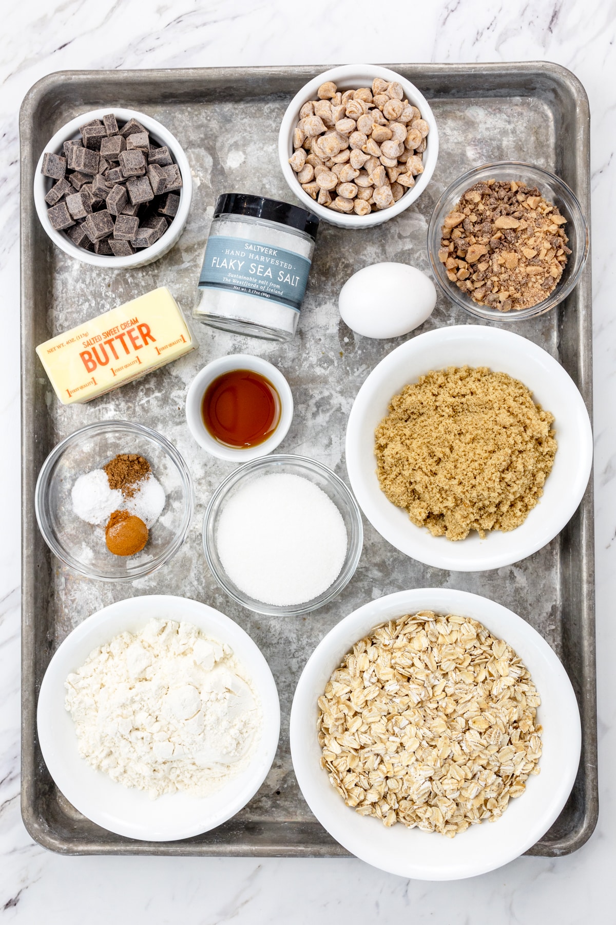 Top view of ingredients needed to make Mom's Recipe Cookies in small bowls on a tray.