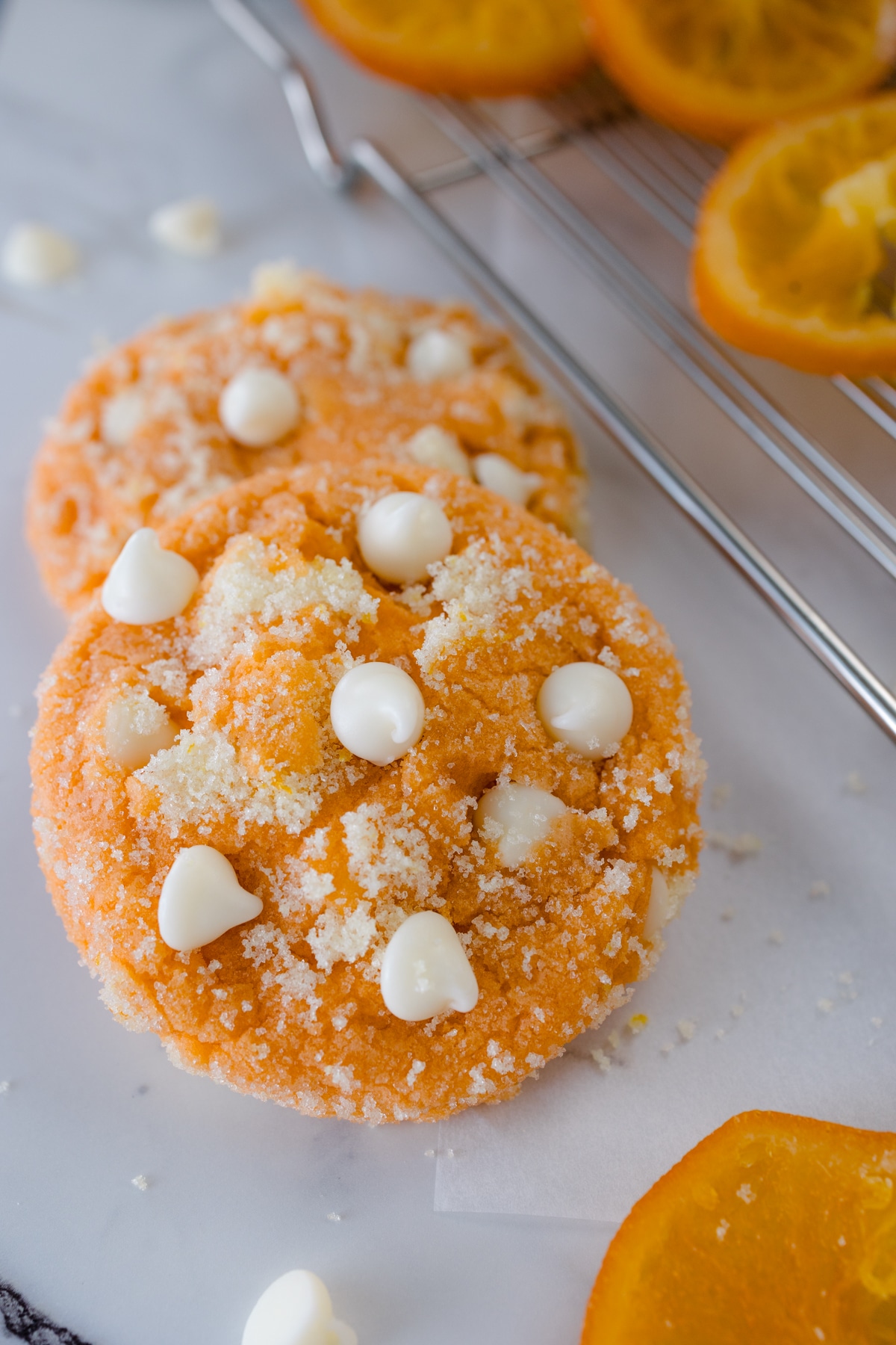 Close up of orange creamsicle cookies on a white surface.