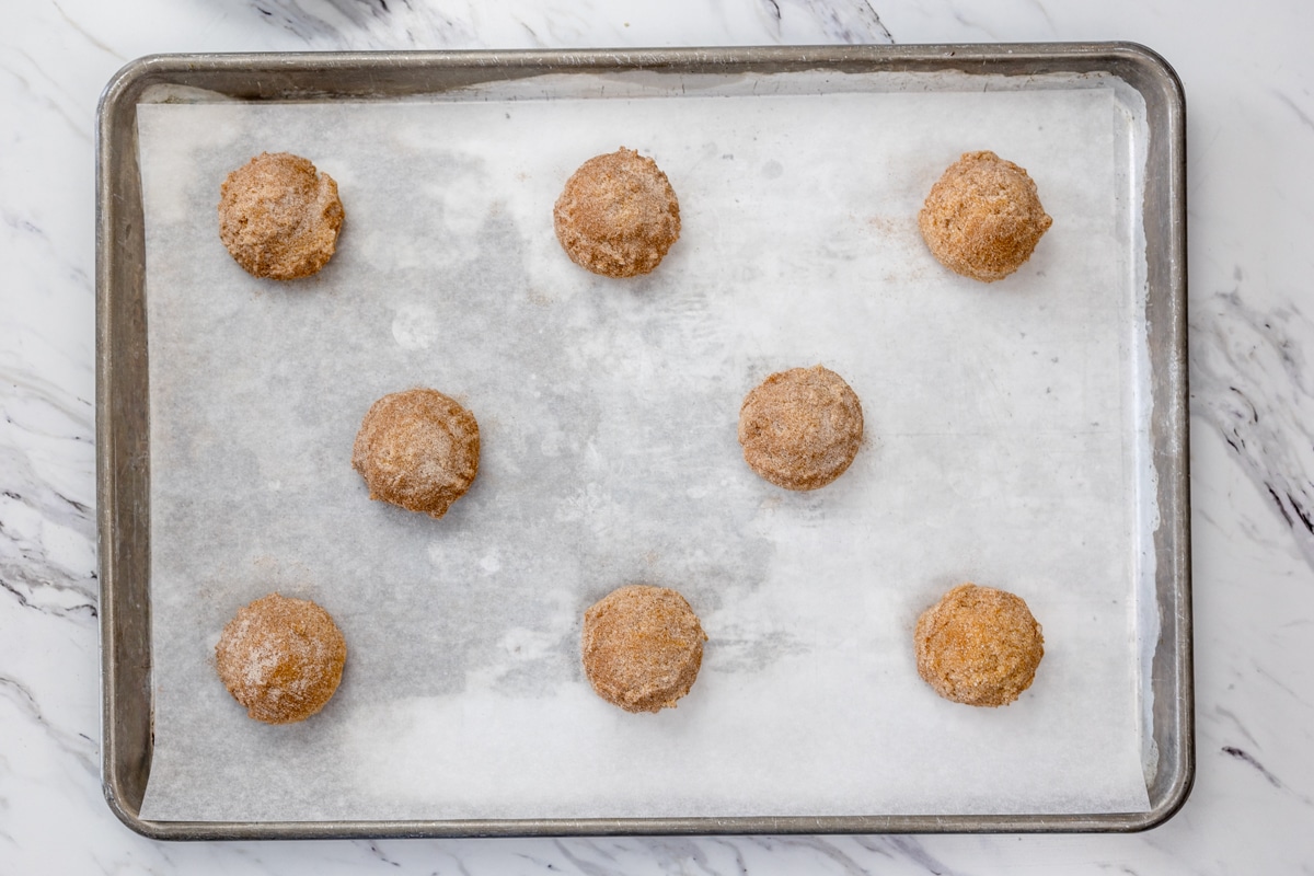 Top view of Pumpkin Snickerdoodle Cookie balls on a baking tray.