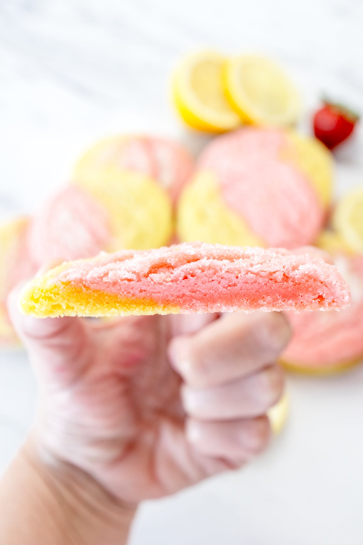 Close up view of Strawberry Lemonade Cookie sliced in half to reveal the middle.