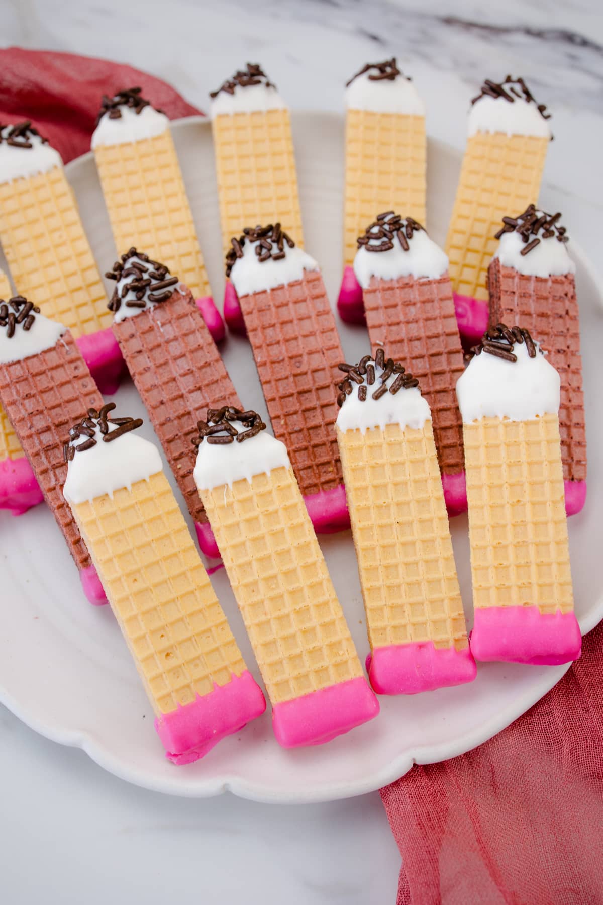 Pencil Wafer Cookies on a white plate.